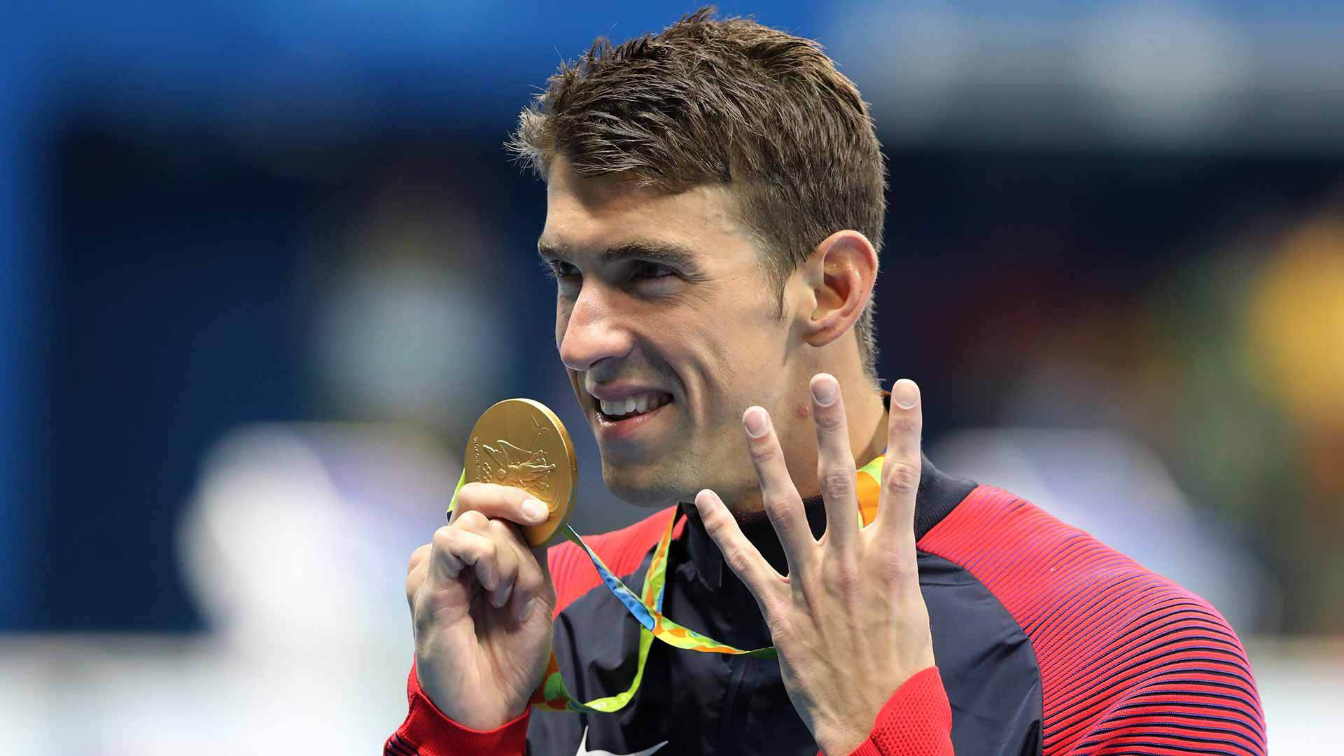 Michael Phelps Displaying Four Victory Signs After Winning