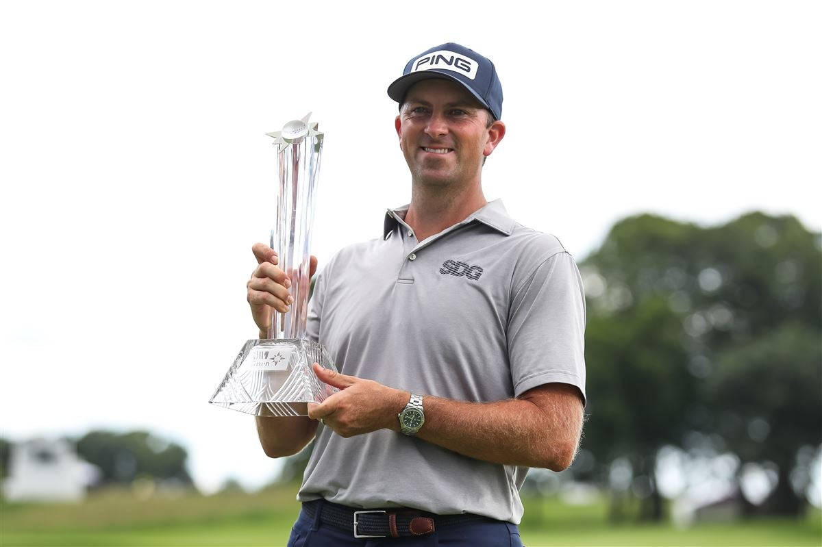 Michael Thompson Holding A Trophy Background