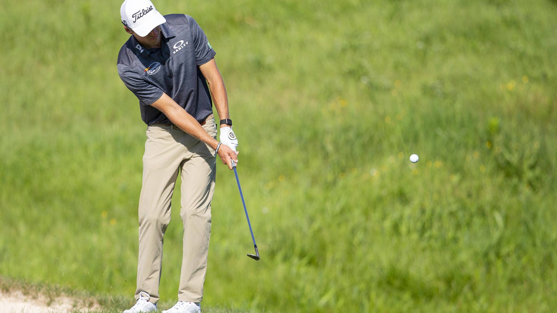 Michael Thompson Preparing For A Powerful Swing On The Golf Field Background