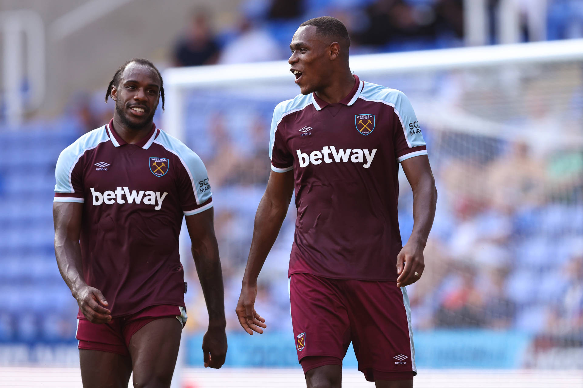 Michail Antonio Walking With Teammate Background