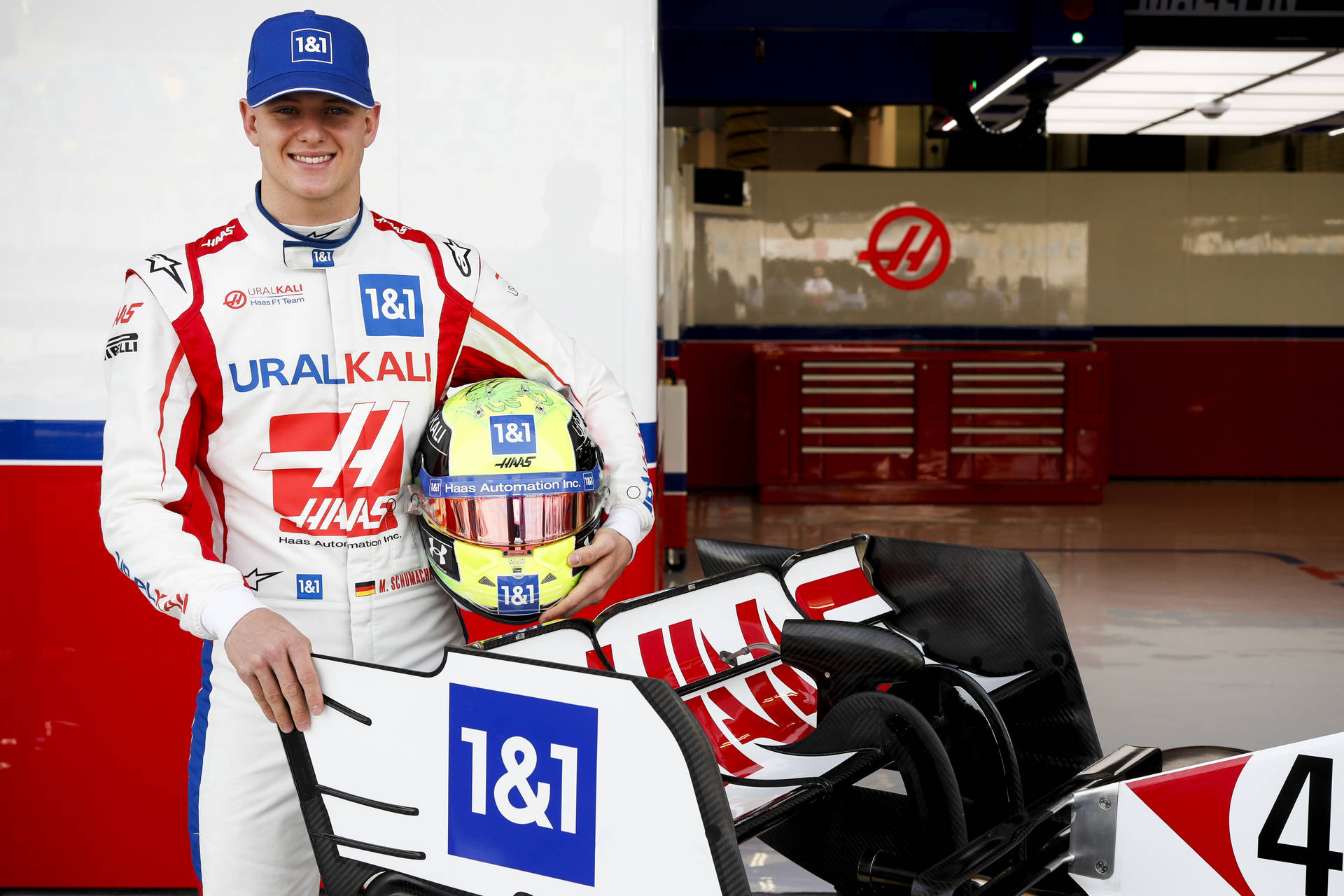 Mick Schumacher Beside A Racing Car