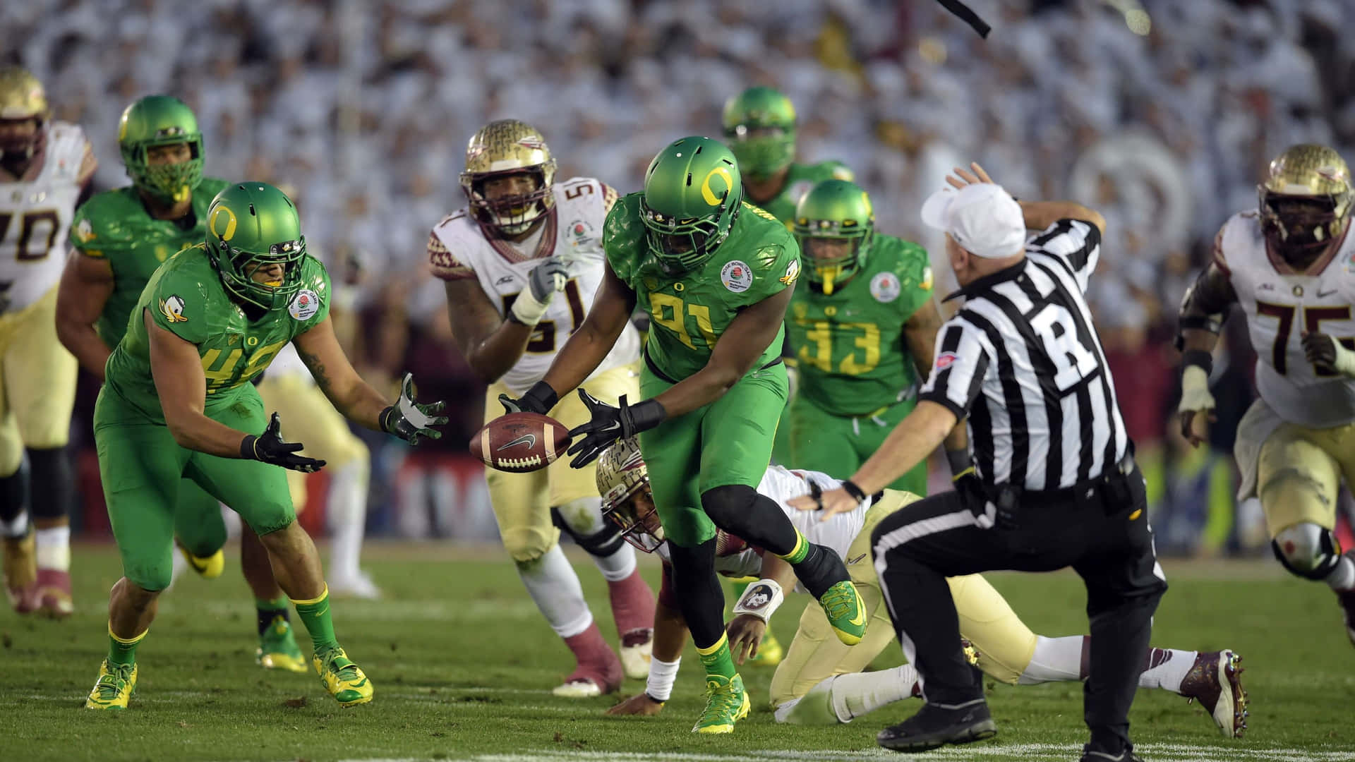 Mighty Oregon Ducks Football Team In Action Background