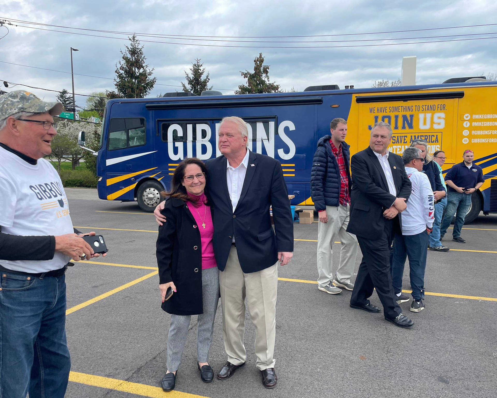 Mike Gibbons Embracing A Woman In An Friendly Event