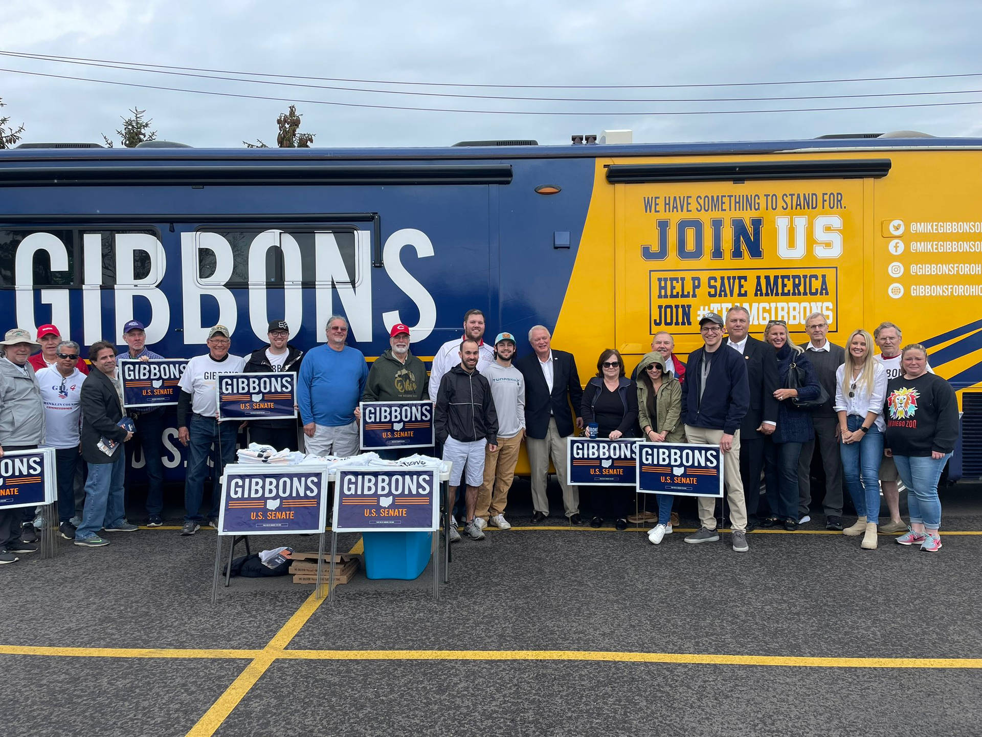 Mike Gibbons Interacting With People By The Bus