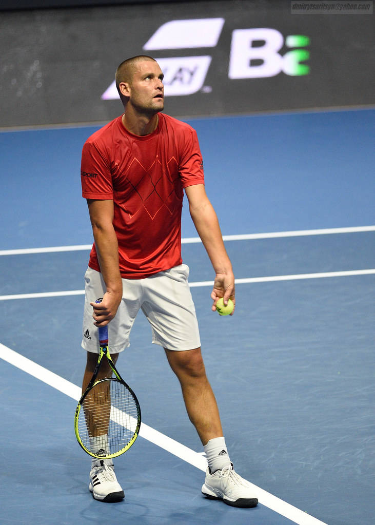 Mikhail Youzhny In Action With A Powerful Serve Background