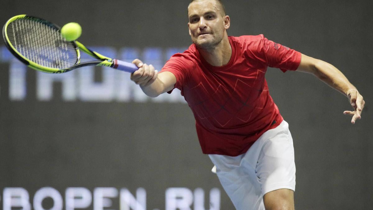 Mikhail Youzhny Reaching Tennis Ball Background