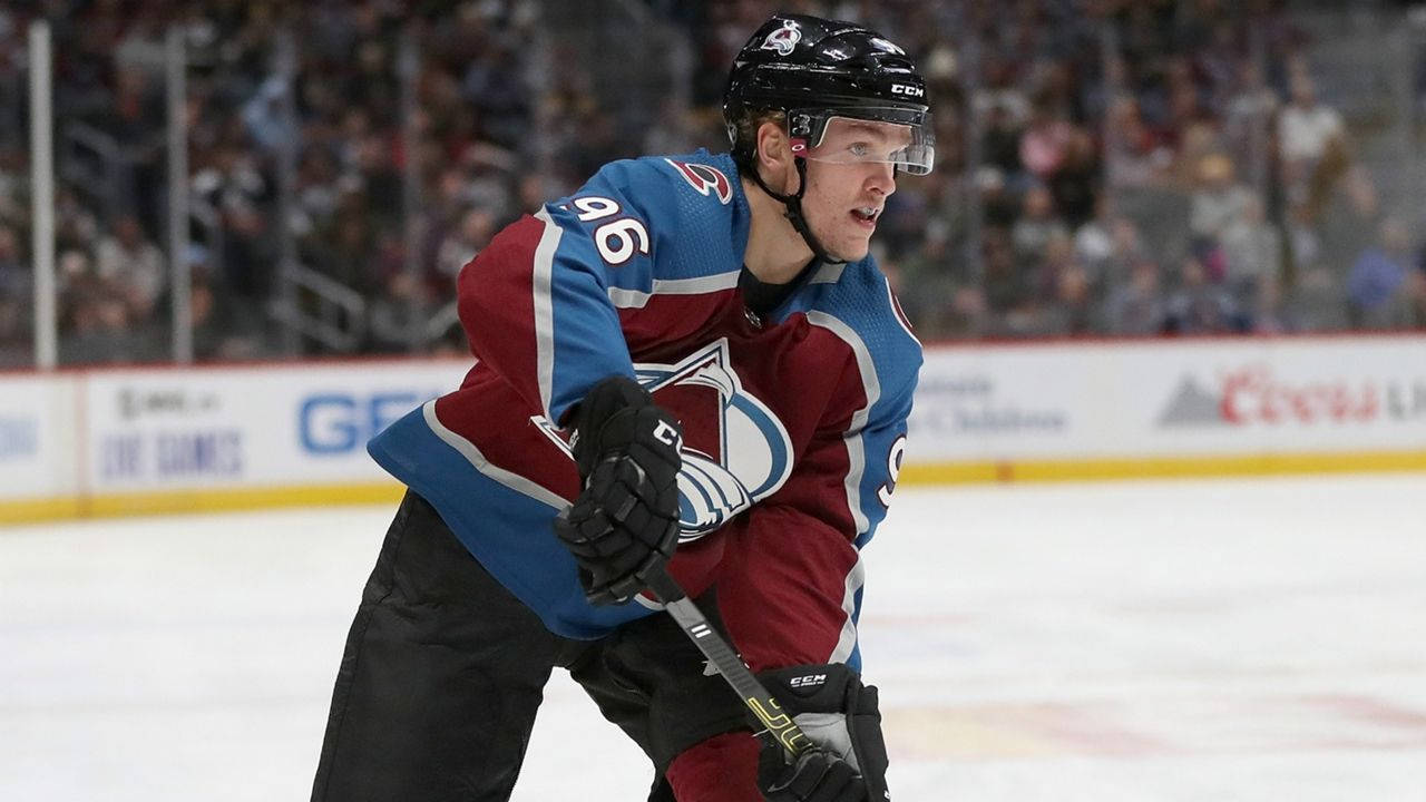 Mikko Rantanen With Mouth Open While Leaning To The Left Background