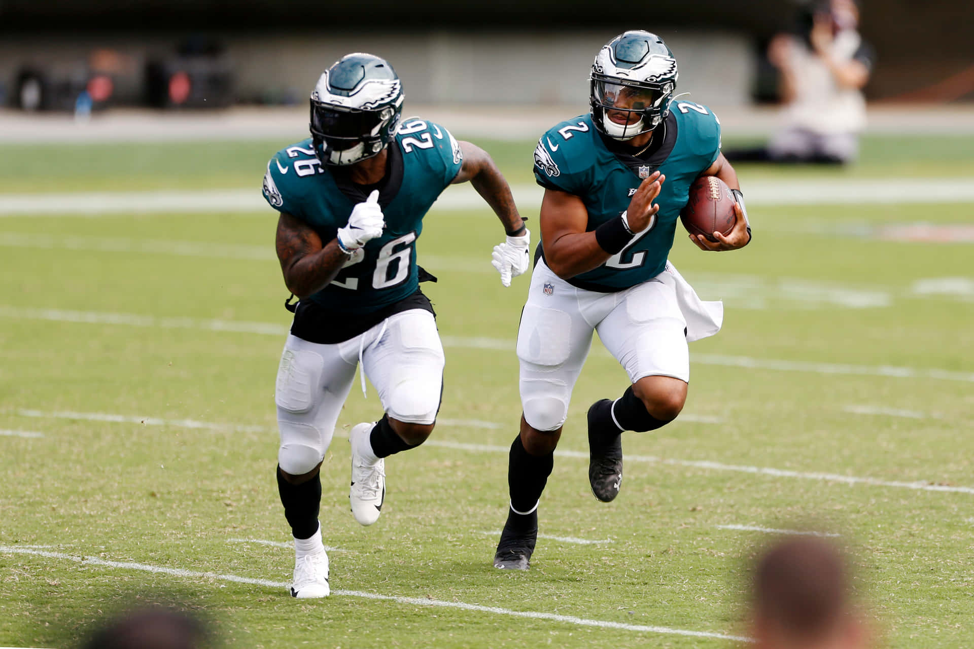 Miles Sanders Running With Teammate Background