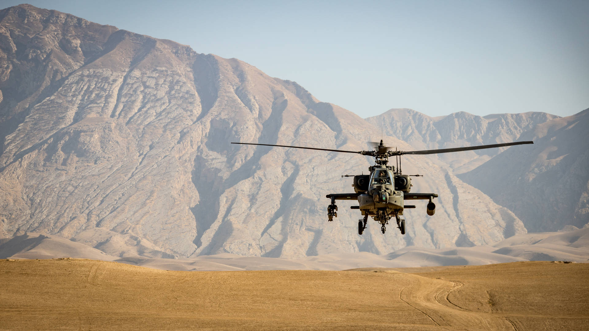 Military Helicopter Landing On Sand Background