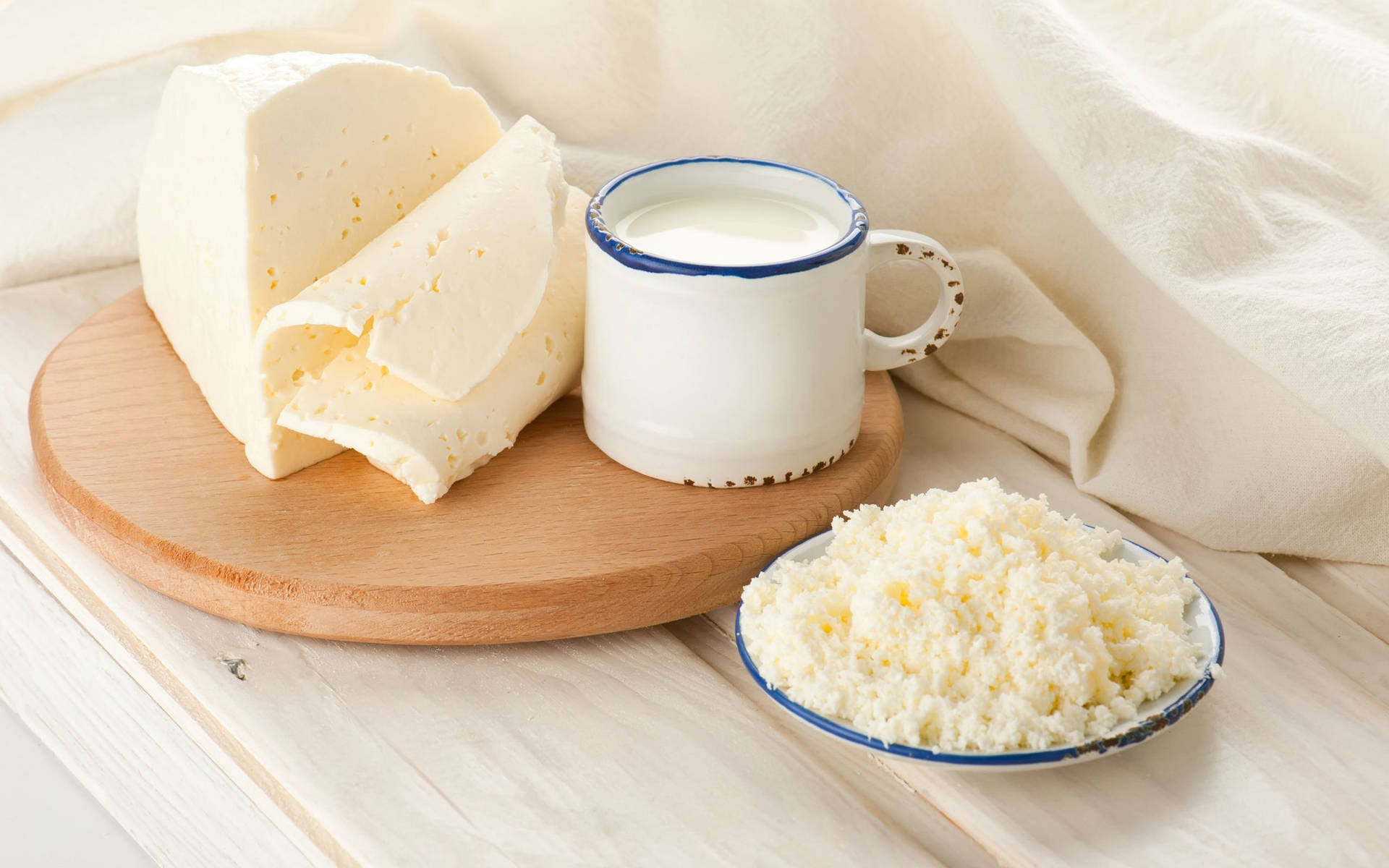 Milk And White Cheese On A Table Background
