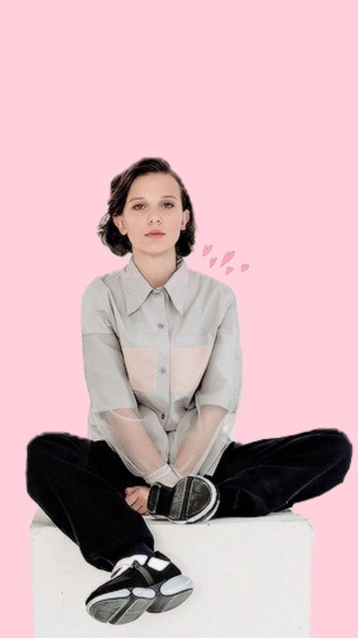 Millie Bobby Brown Poses In An Edgy, Vibrant Outfit Background