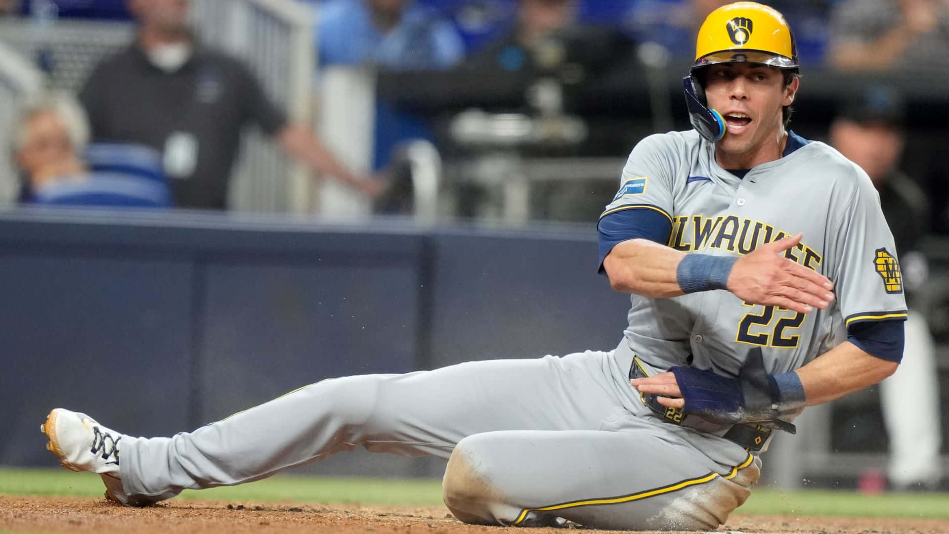Milwaukee Brewers Player Sliding Into Base Background