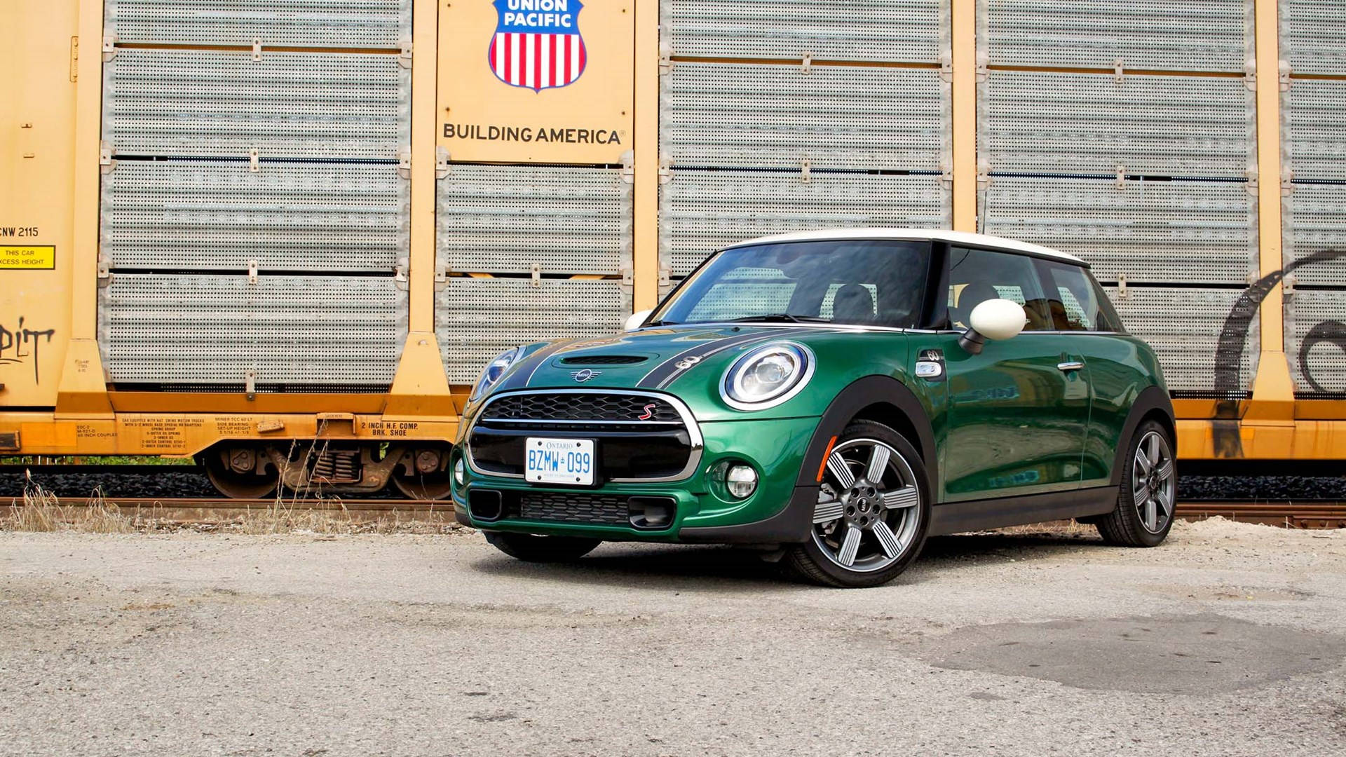 Mini Green Car Outside Gold Building