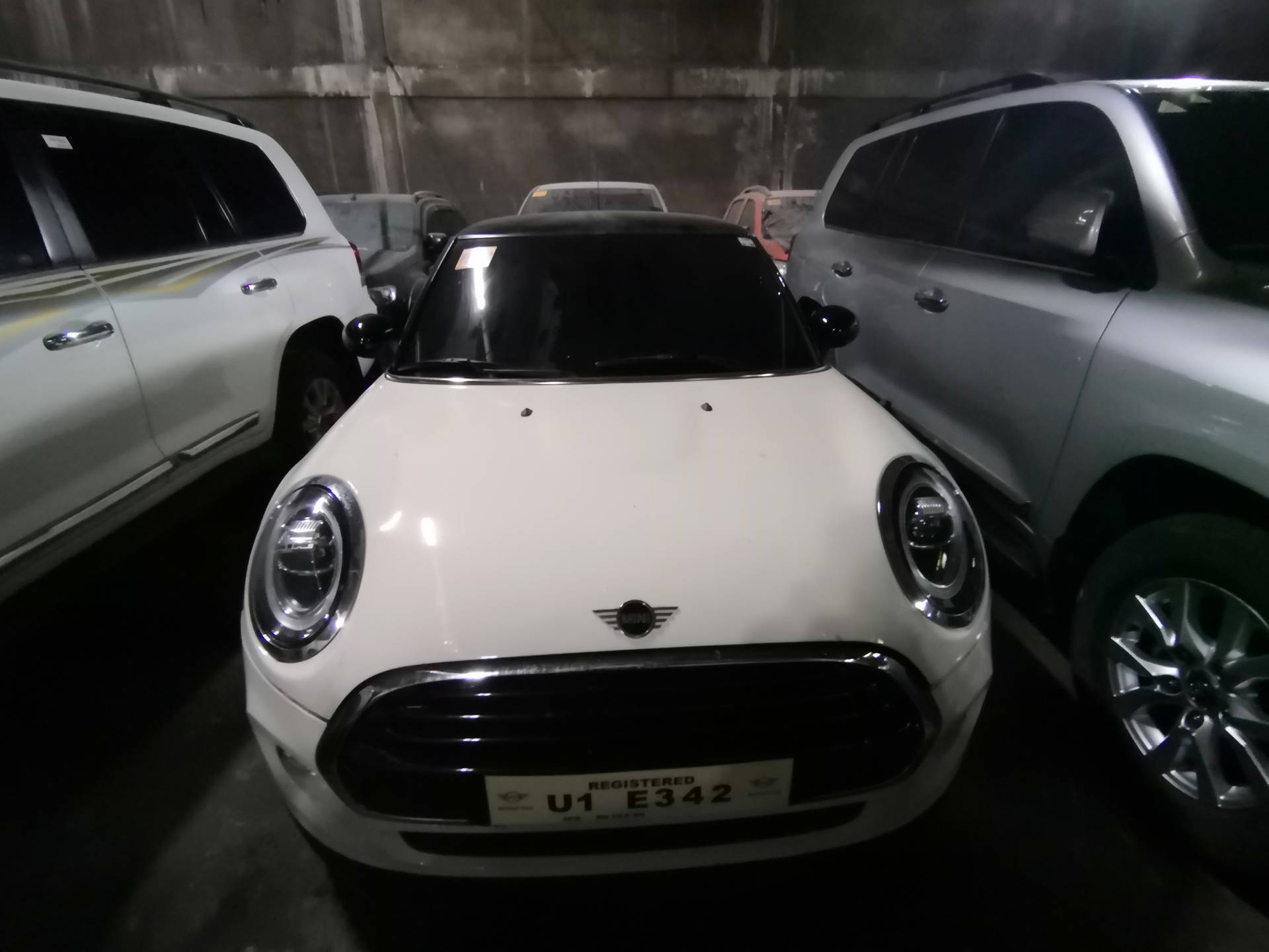 Mini White Car In Between Two Cars