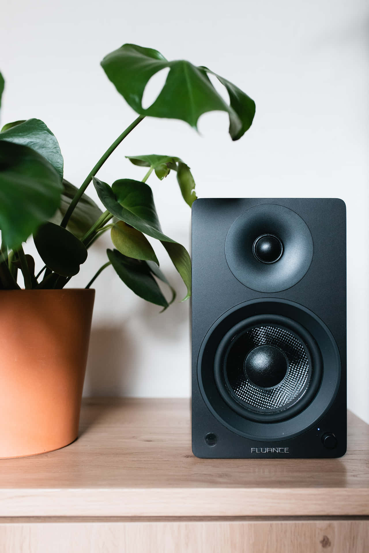 Minimalist Black Music Speaker On Table Background