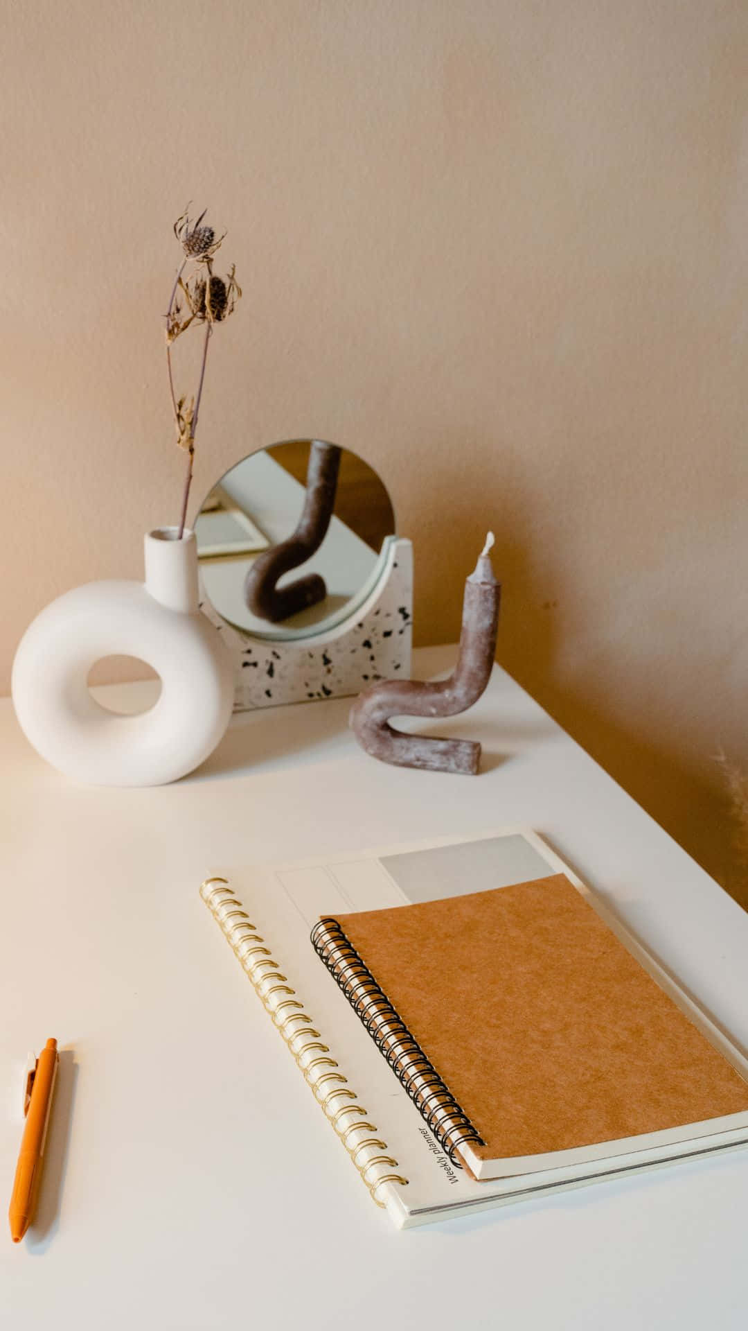 Minimalist Desk Setupwith Notebookand Decor Background