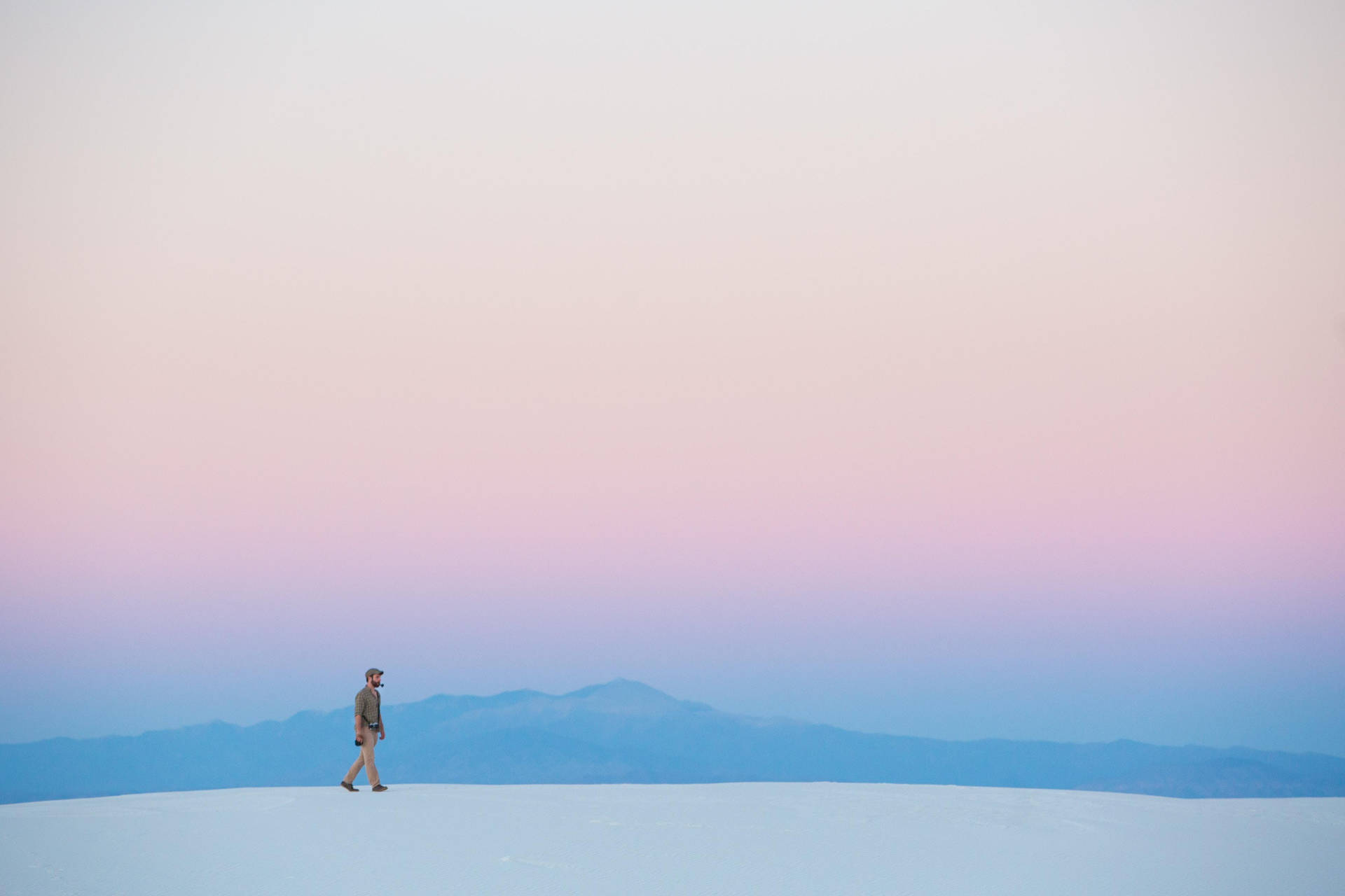 Minimalist Desktop Man Walking On Sand Background