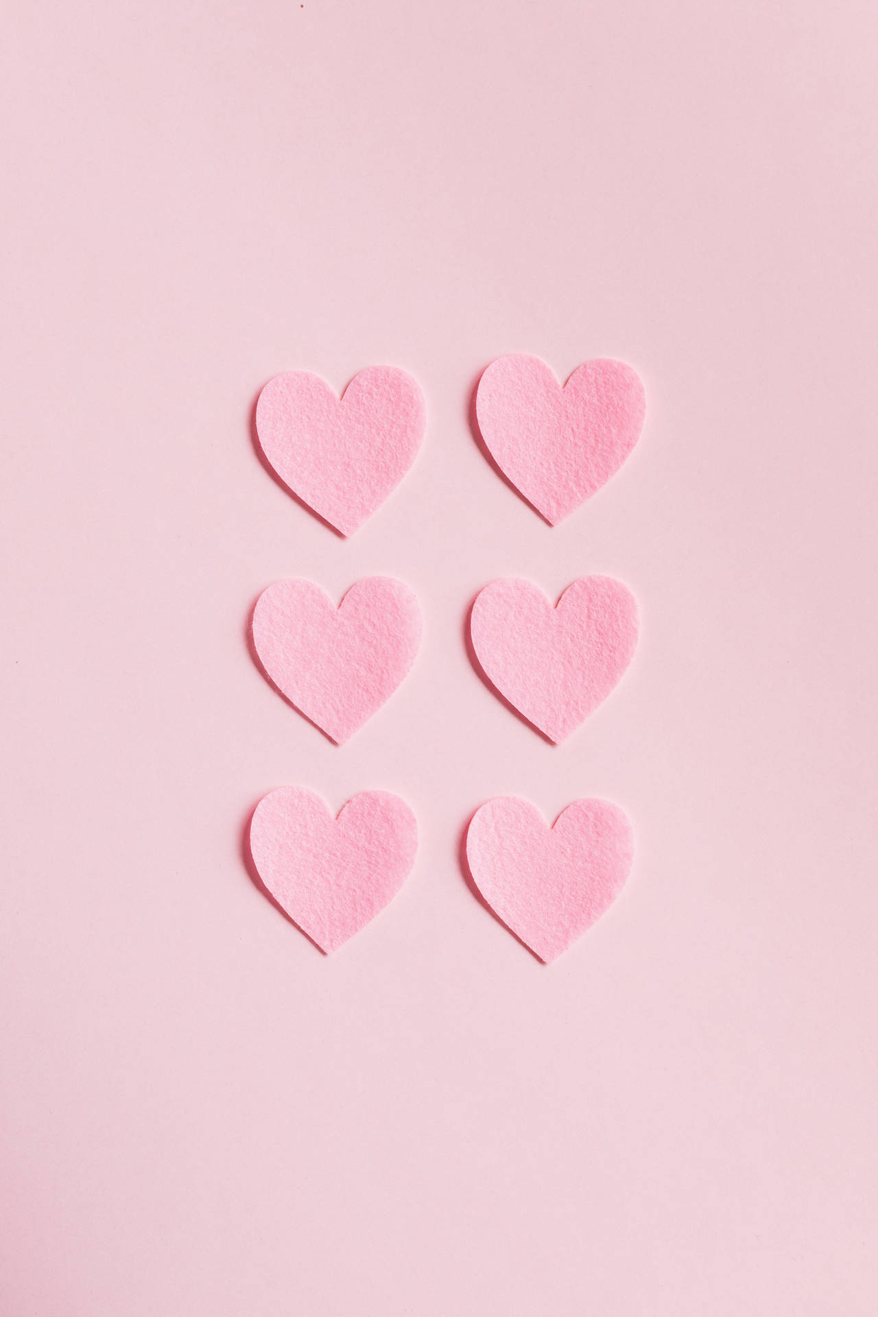 Minimalist Hearts On Pastel Pink Colors Background