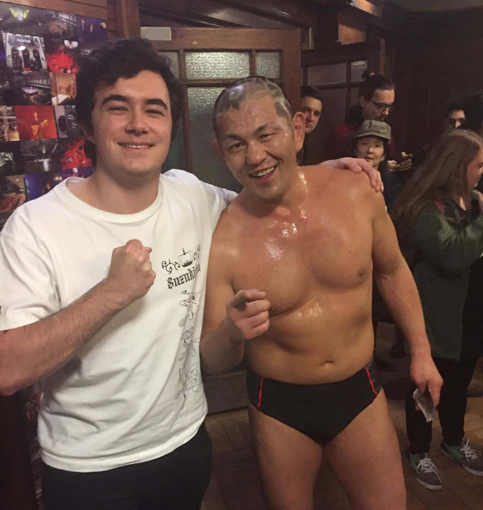 Minoru Suzuki Taking A Selfie With A Lucky Fan Background