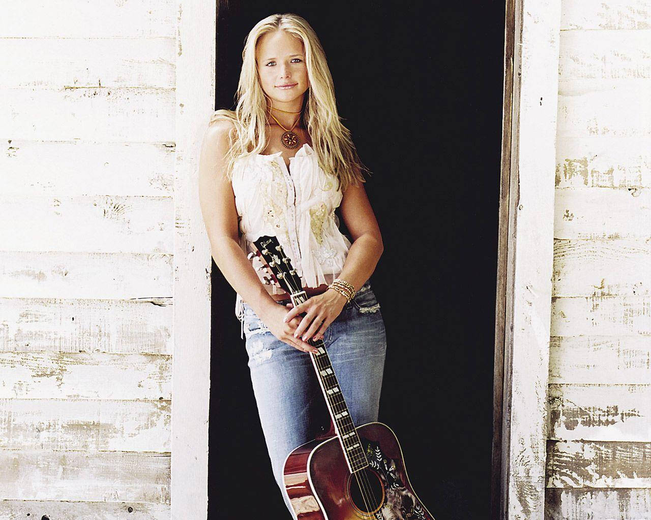 Miranda Lambert Leaning On Door Frame Background