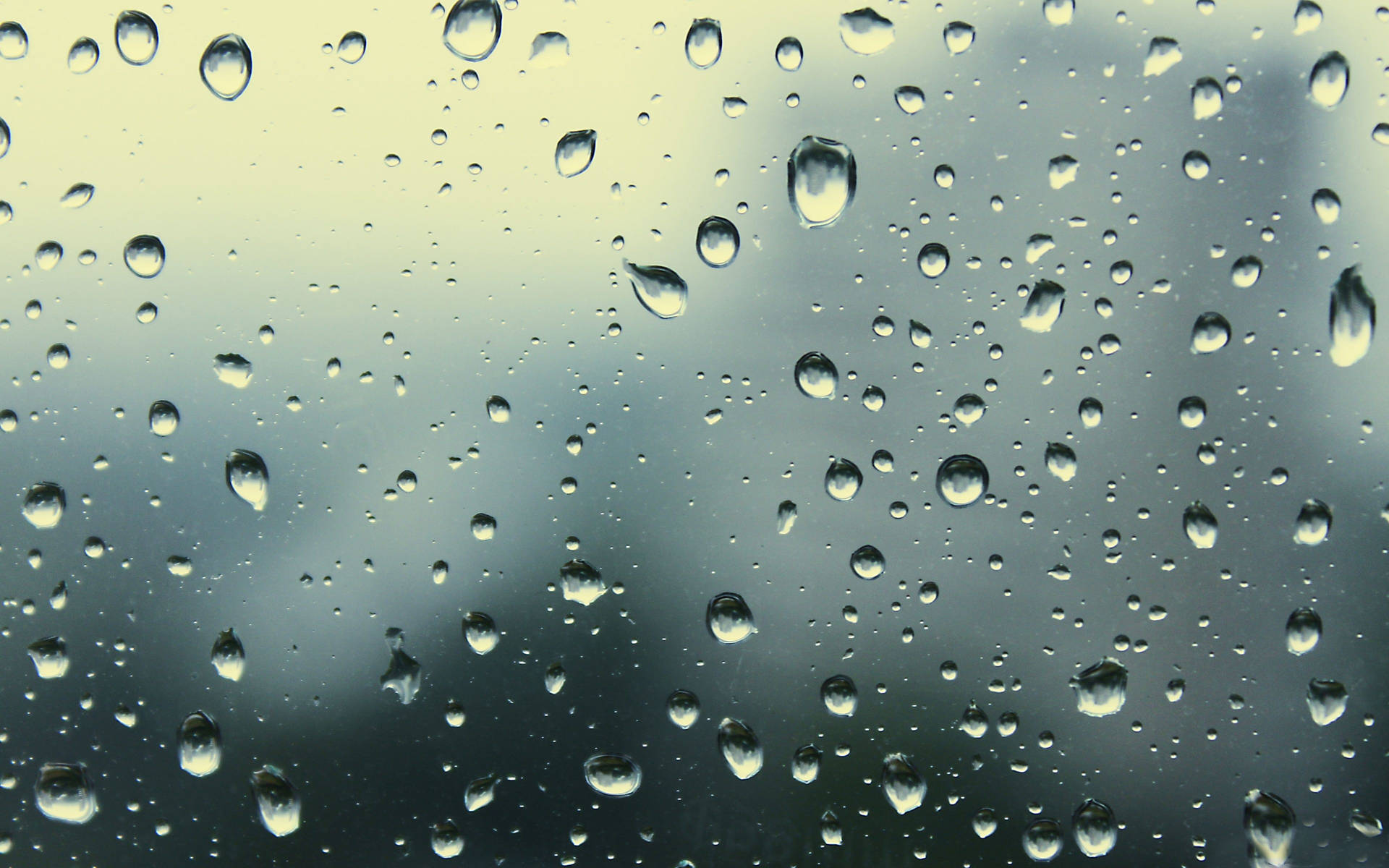 Misty Raindrops On A Glass Pane Background