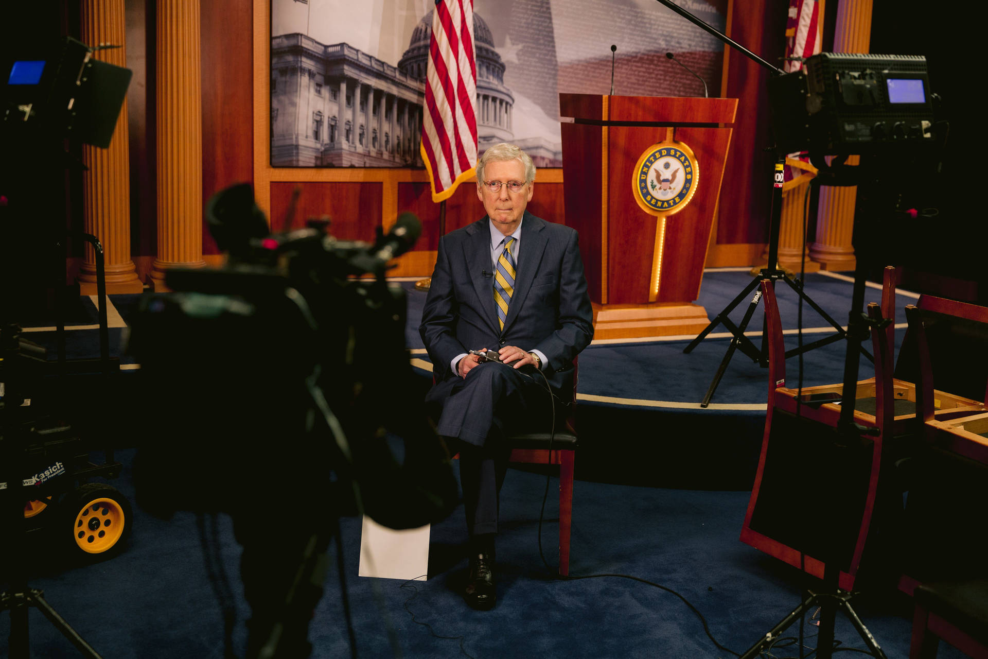 Mitch Mcconnell In Front Of Video Cameras Background