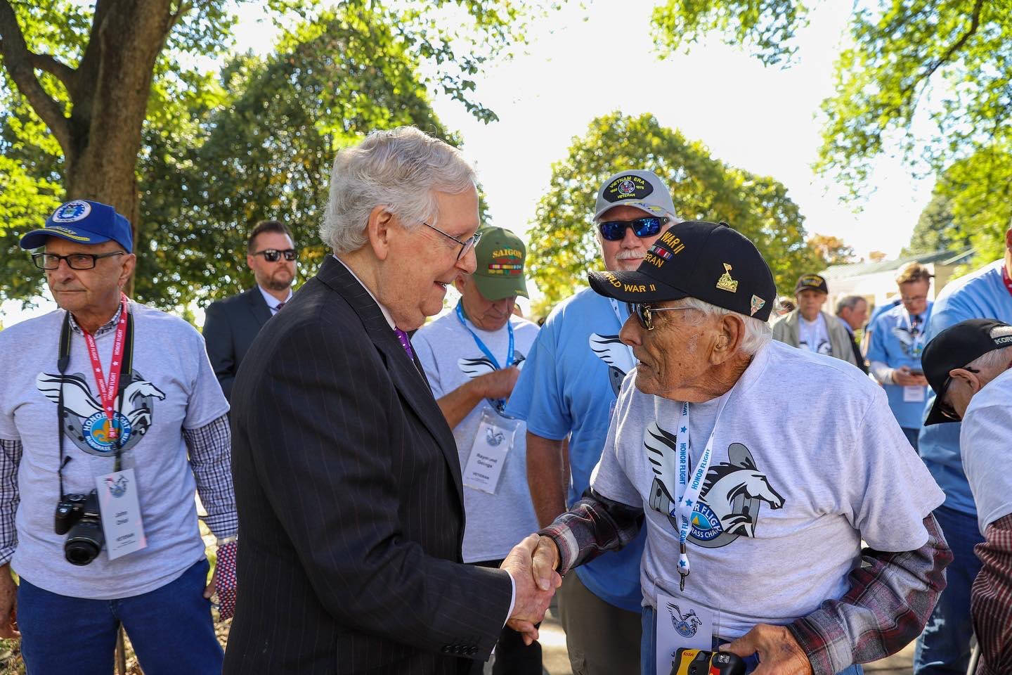 Mitch Mcconnell Shakes Hands With Senior Citizen Background