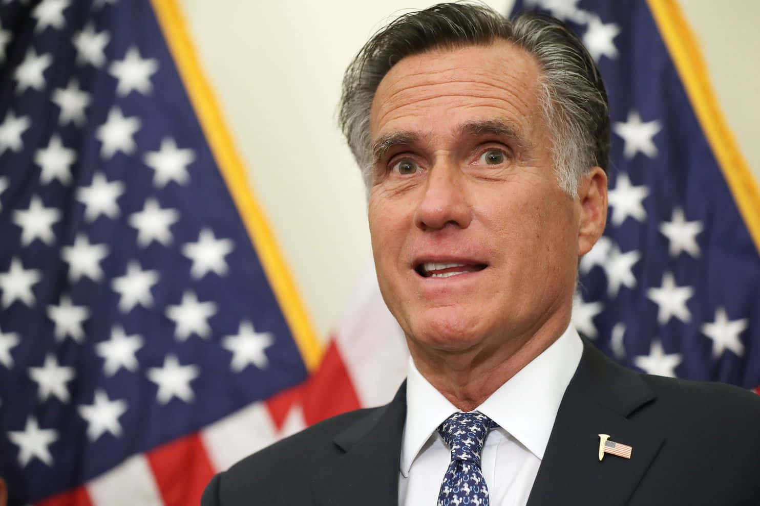 Mitt Romney Speakingwith American Flags Background