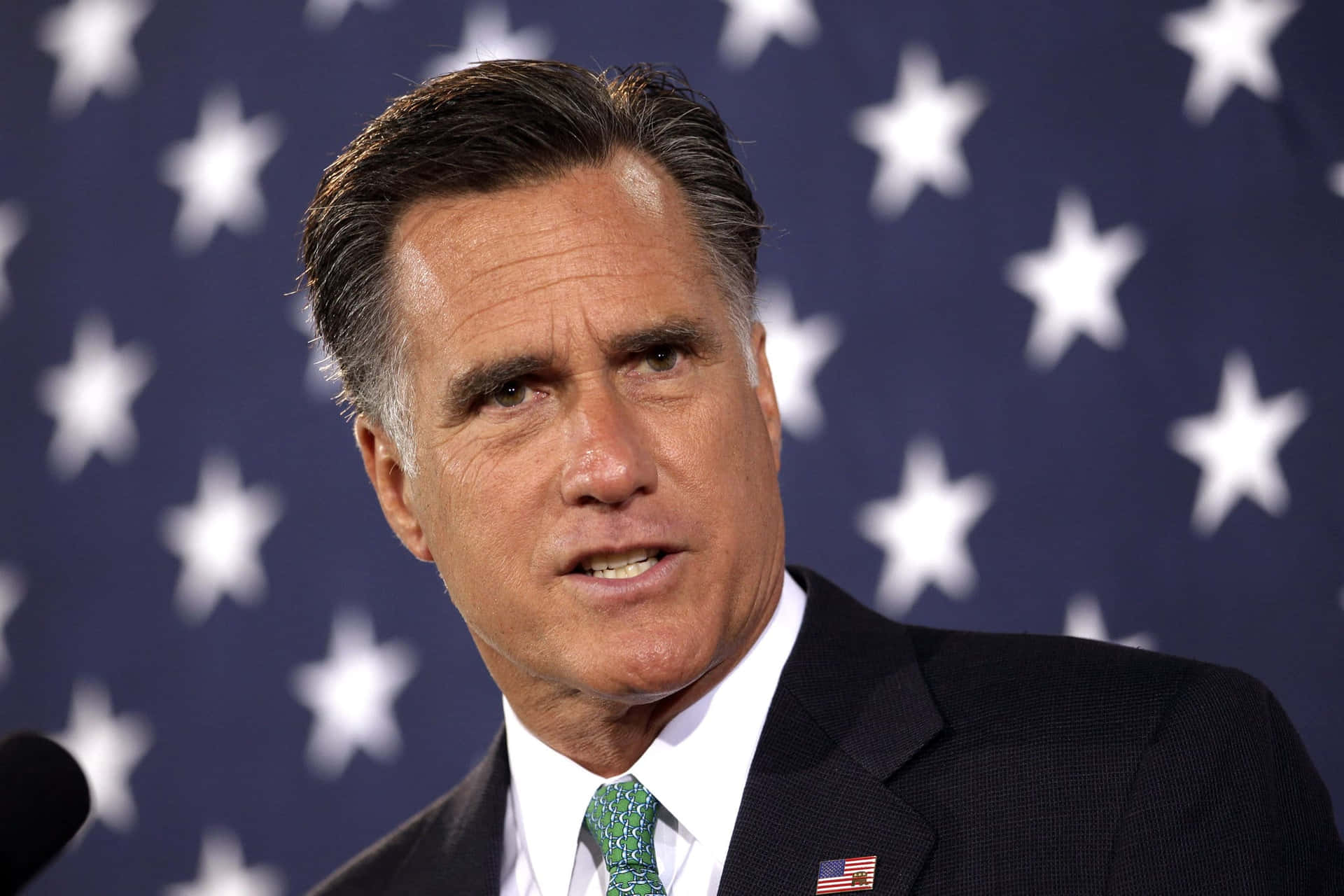 Mitt Romney Speakingwith Flag Background