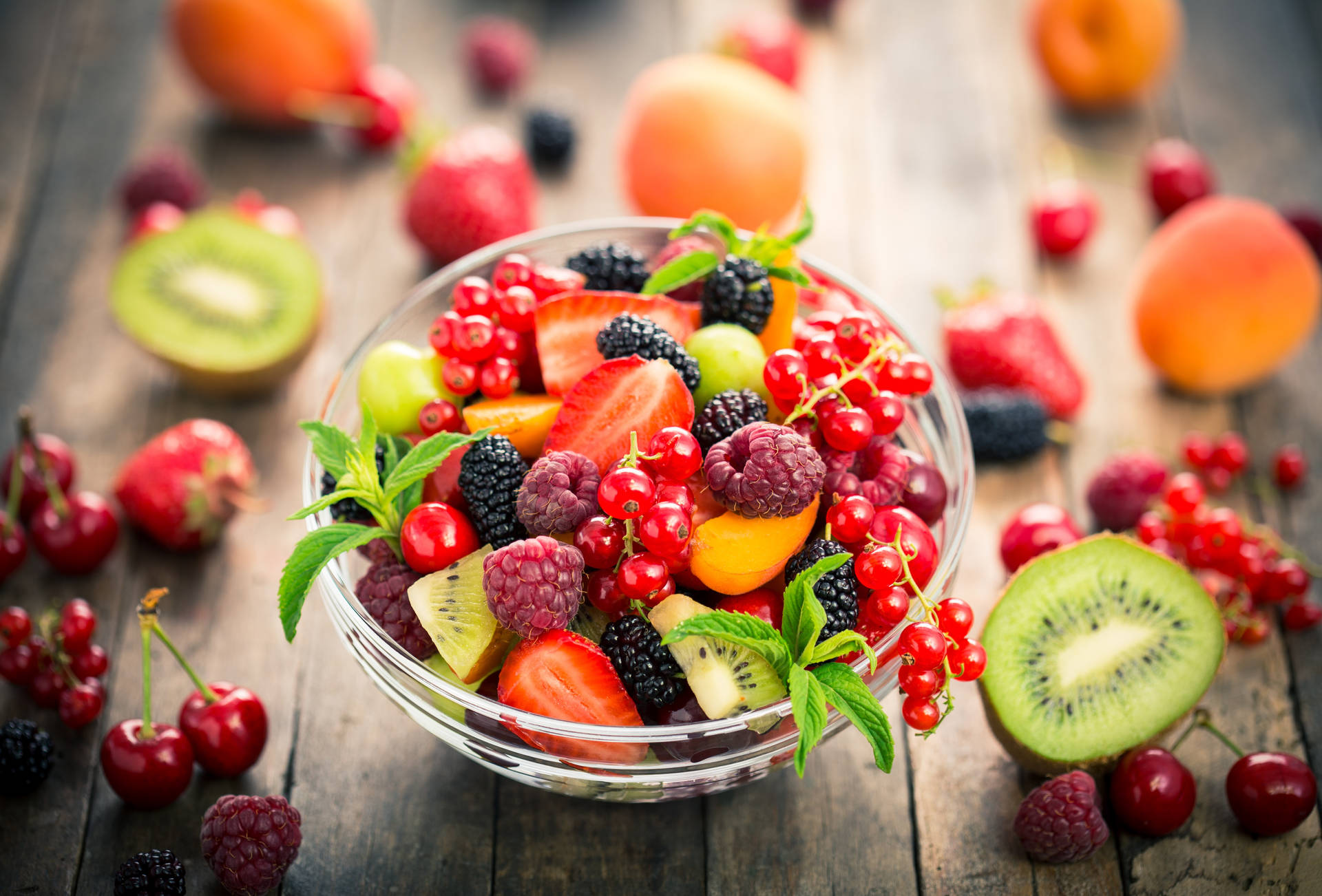 Mixed Fruits And Berries In Glass Bowl