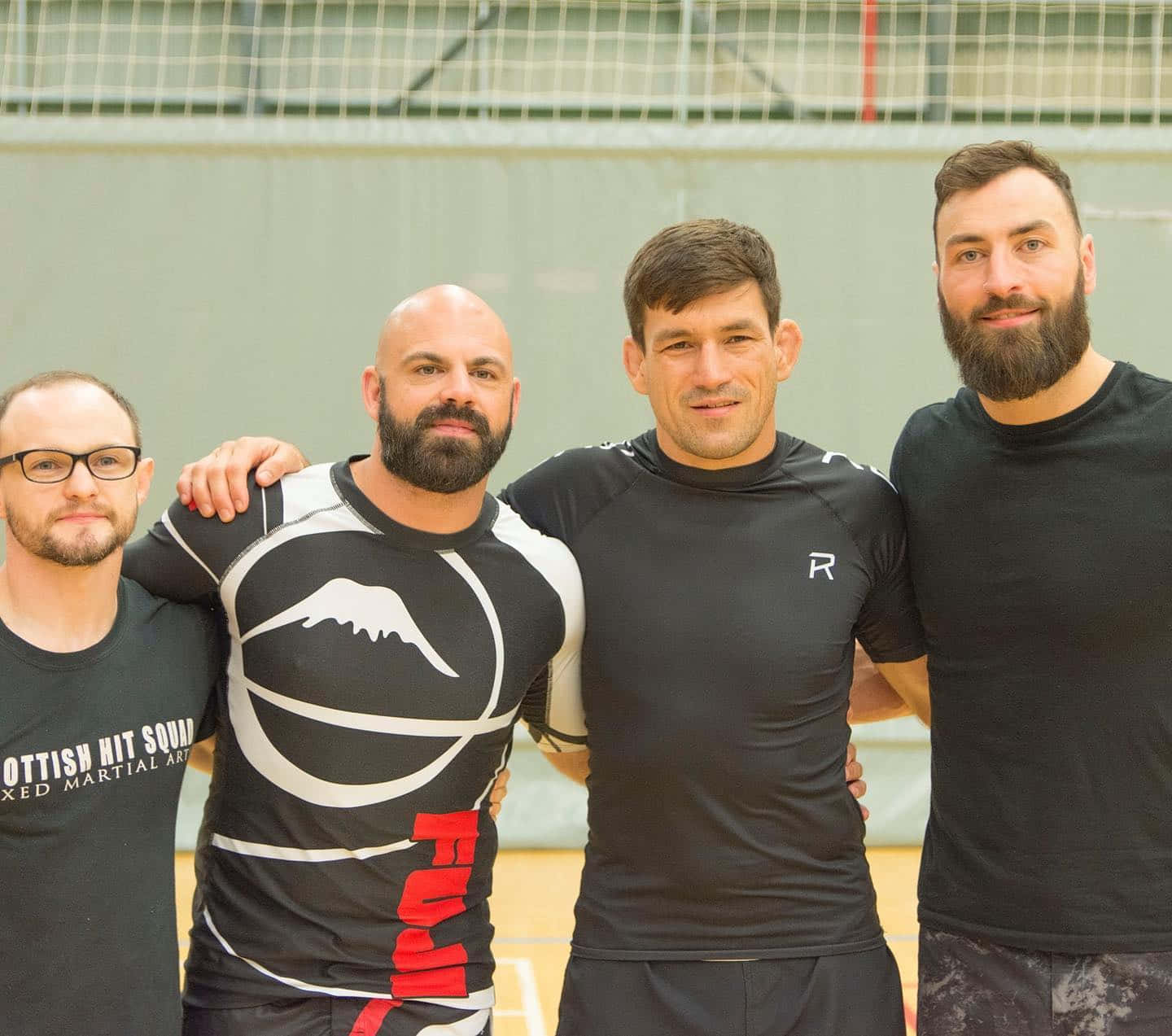 Mma Fighter Paul Craig Posing With Fellow Athletes Background