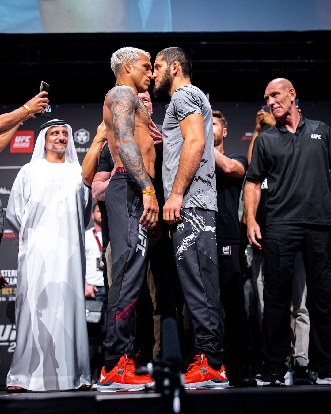 Mma Fighters Islam Makhachev And Charles Oliveira In A Gripping Face-off. Background