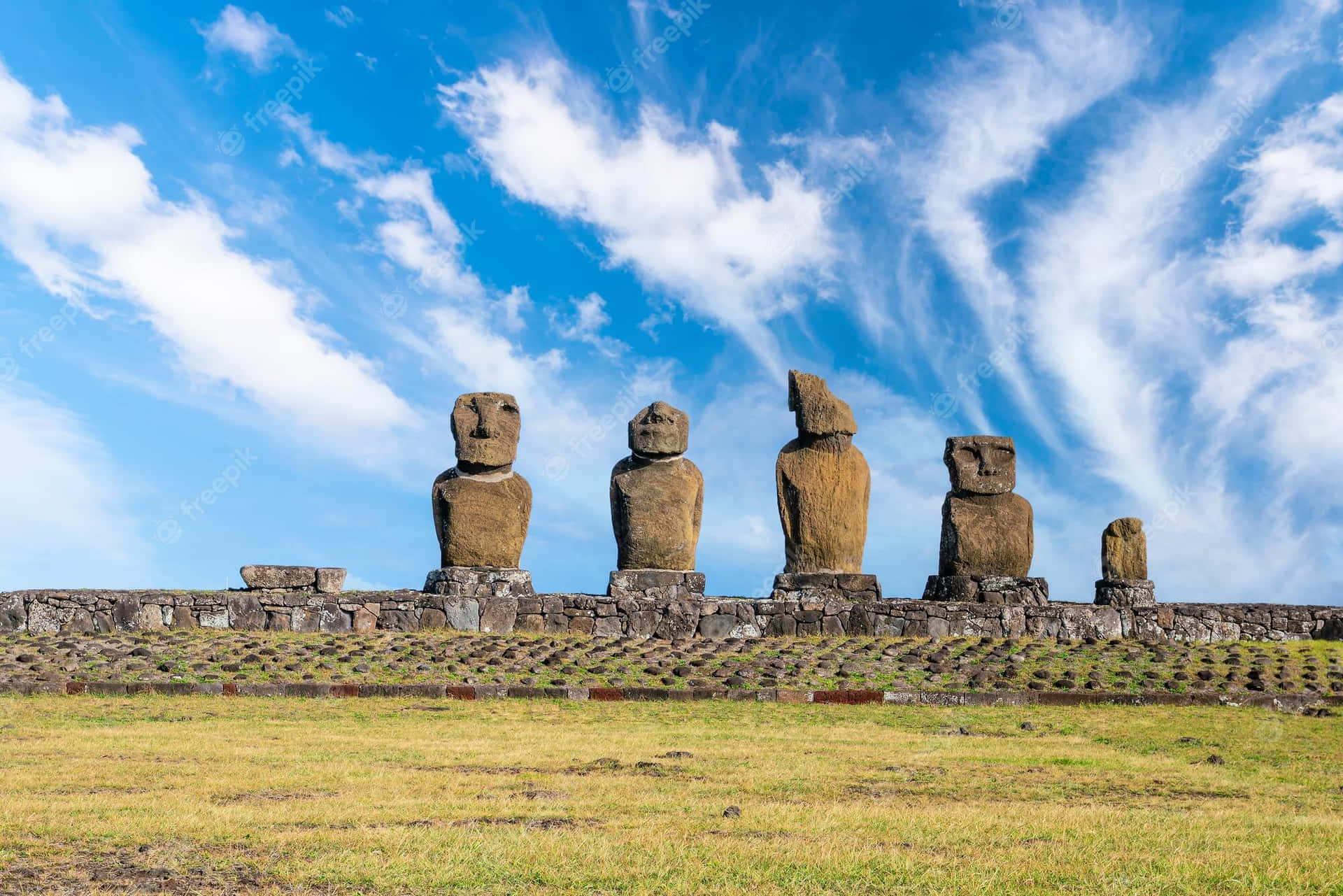 Moai Sculptures Under The Blue Sky Background