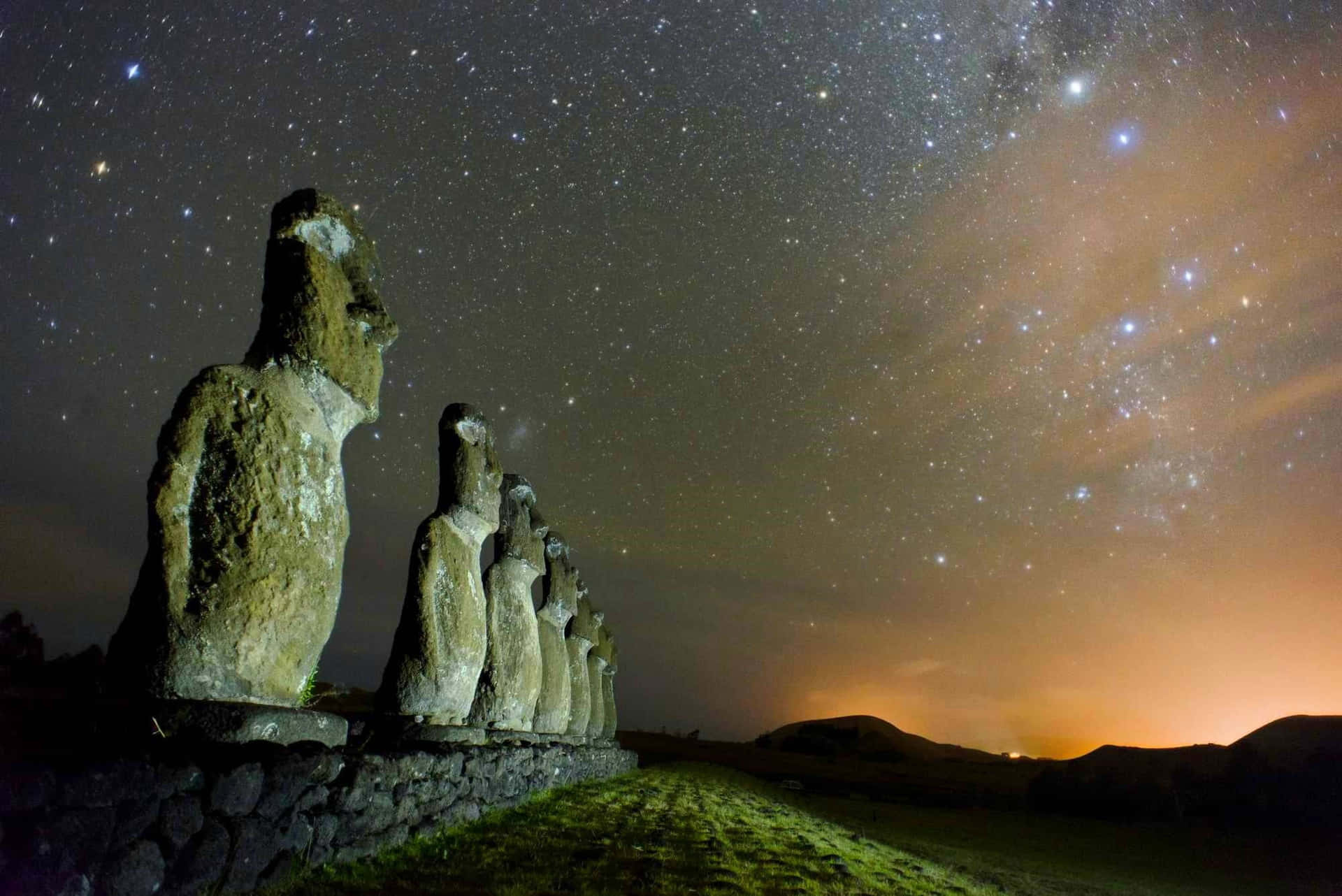 Moai Statues Across Shiny Stars Background