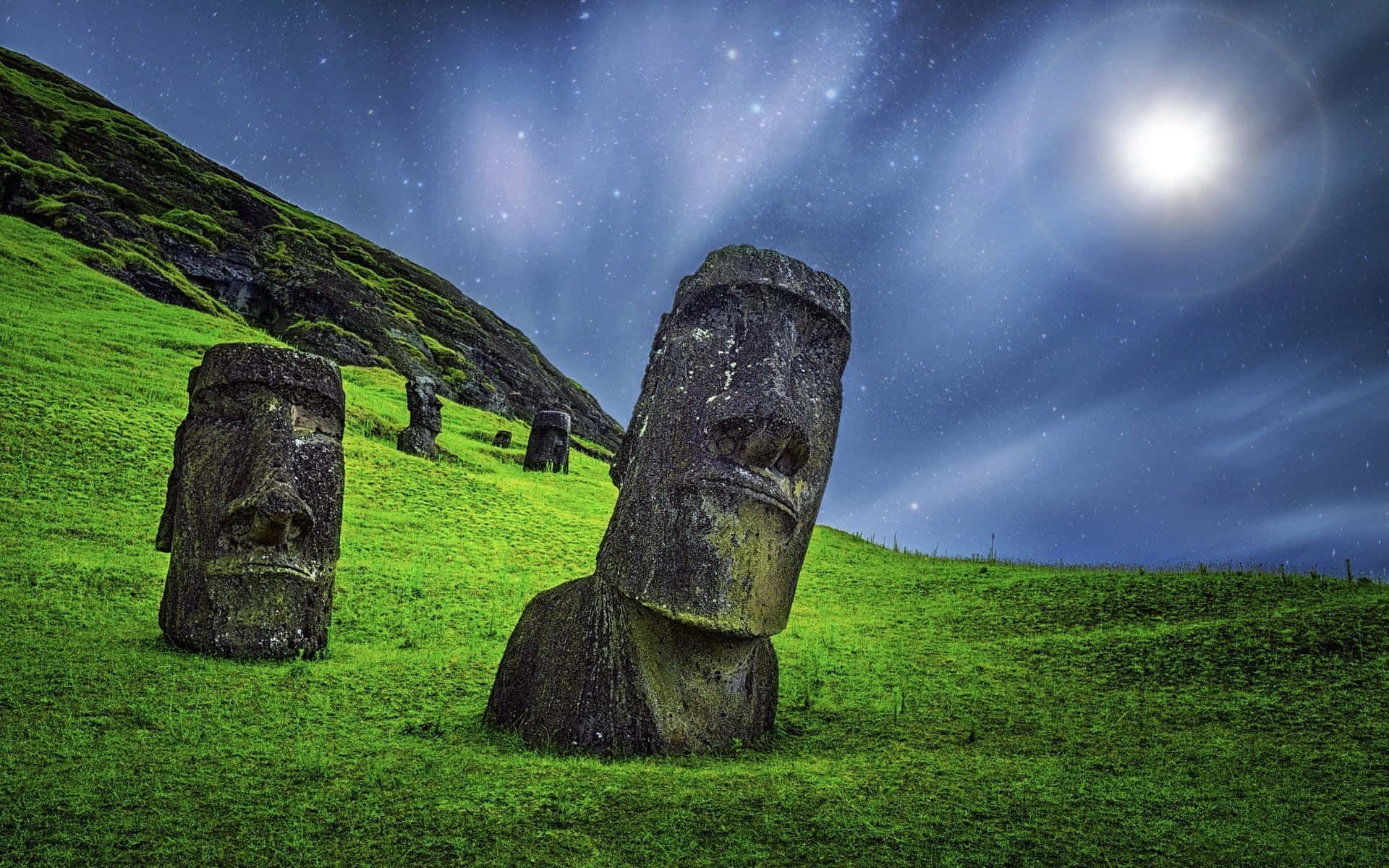 Moai Statues On Vibrant Green Grass Background