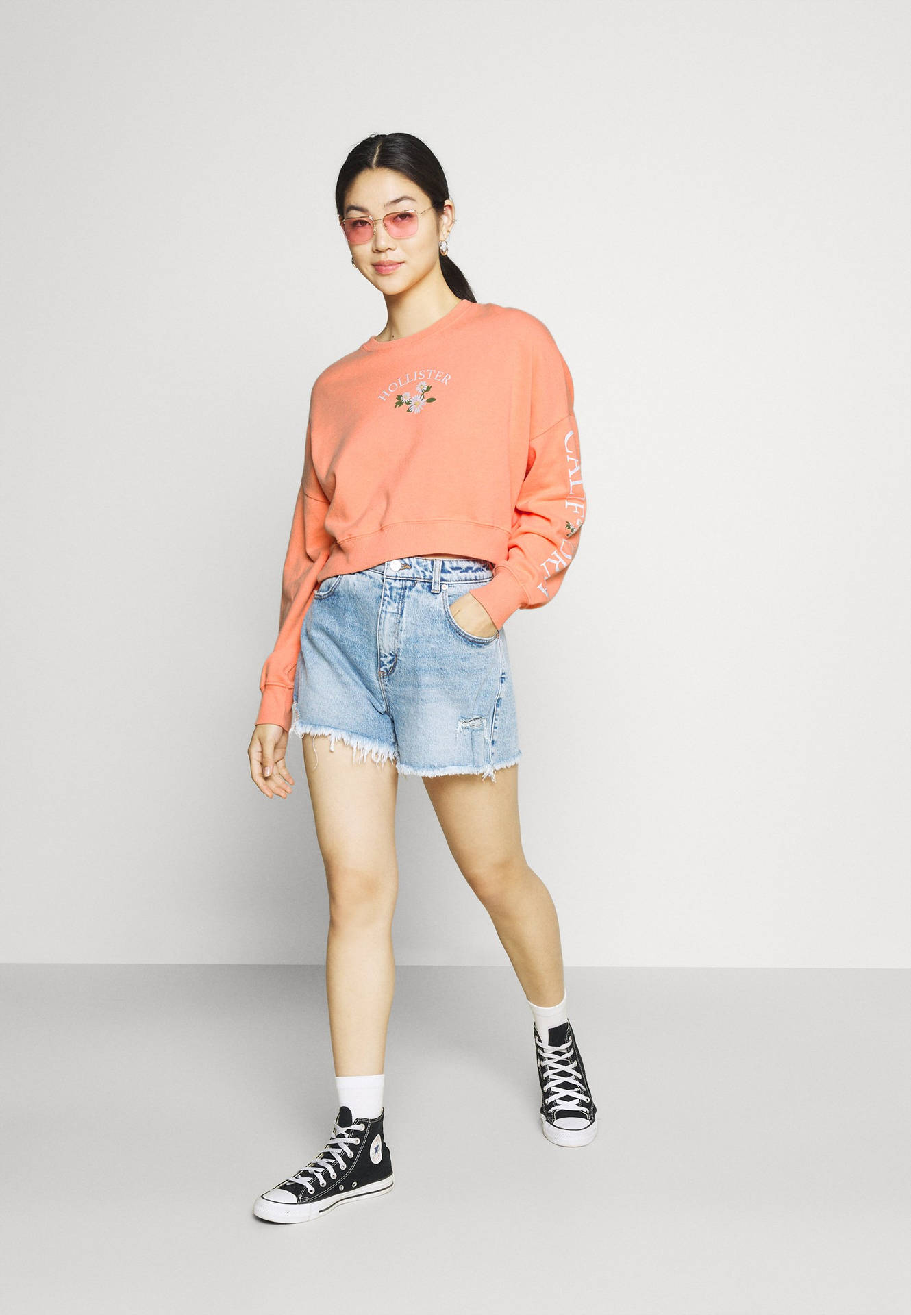 Model In Peach Hollister Sweatshirt Background