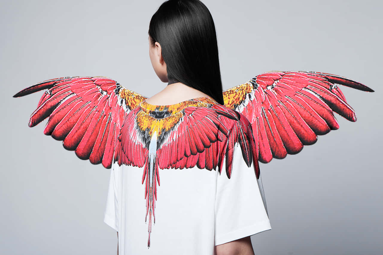 Model Wearing Red Wings Marcelo Burlon Background