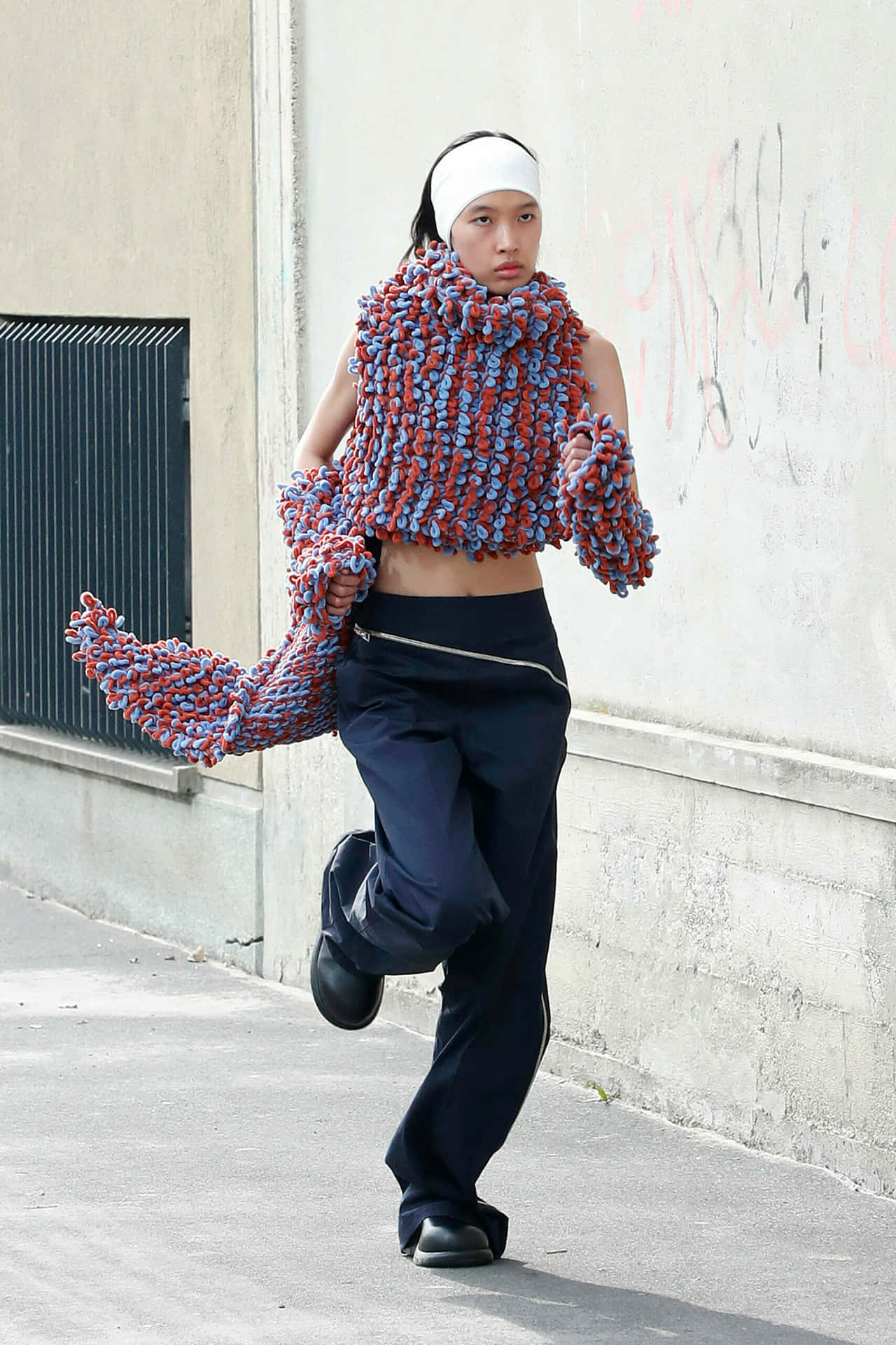 Model With Bulky Knitted Top From Sunnei Background