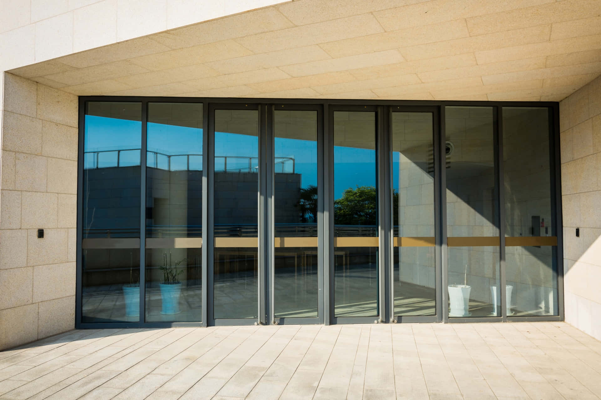 Modern Commercial Building With Automatic Sliding Doors Background