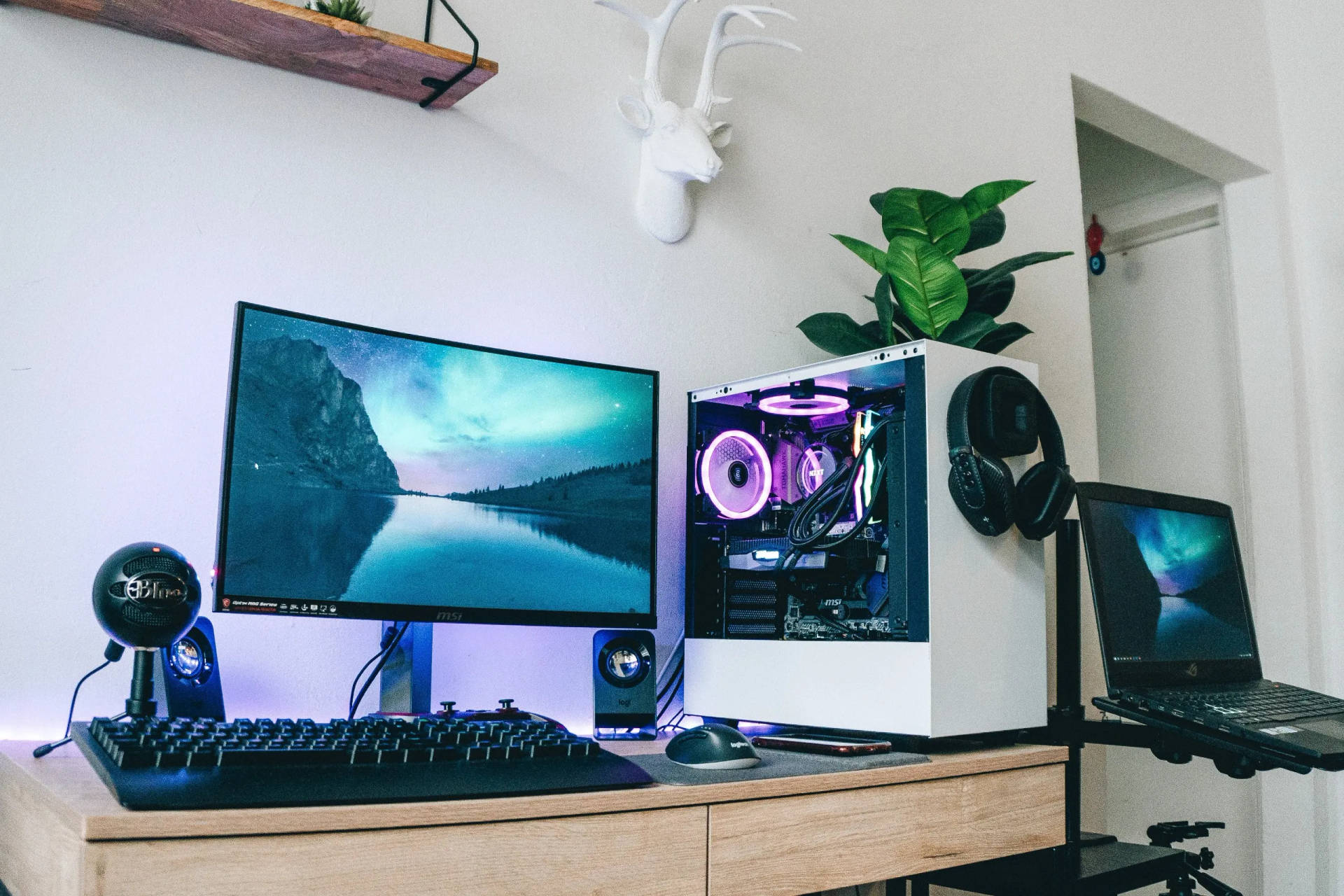 Modern Desktop Computer And Laptop On A Table Background