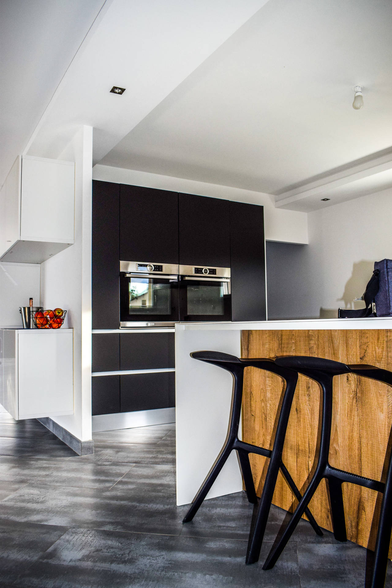 Modern Kitchen With Sleek Design And Black Stools Background