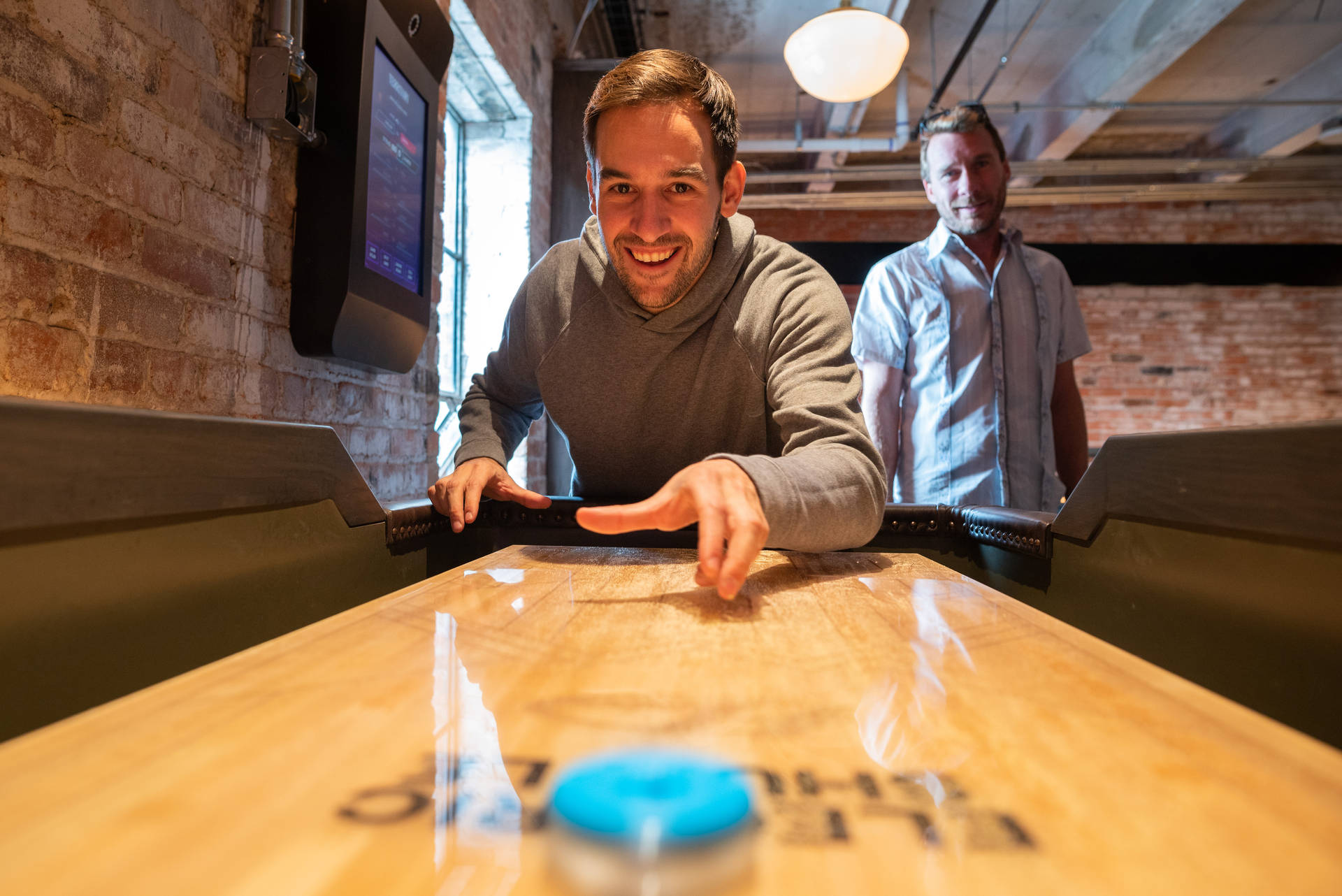 Modern Shuffleboard Table With Blue Puck Background