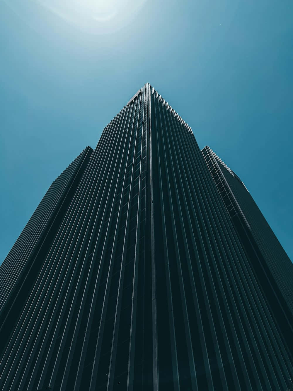 Modern_ Skyscraper_ Against_ Blue_ Sky Background