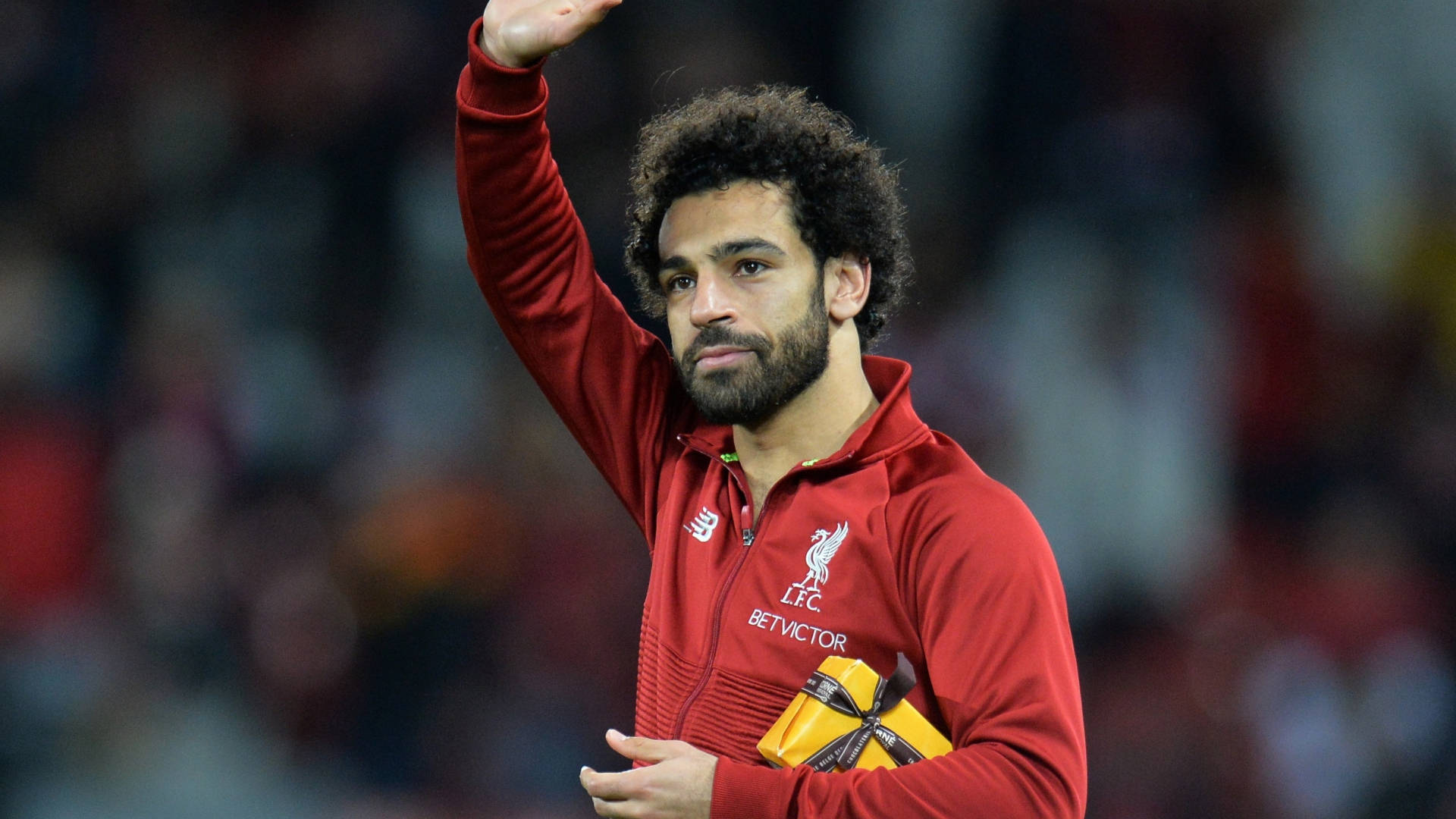 Mohamed Salah Waving With A Gift Background