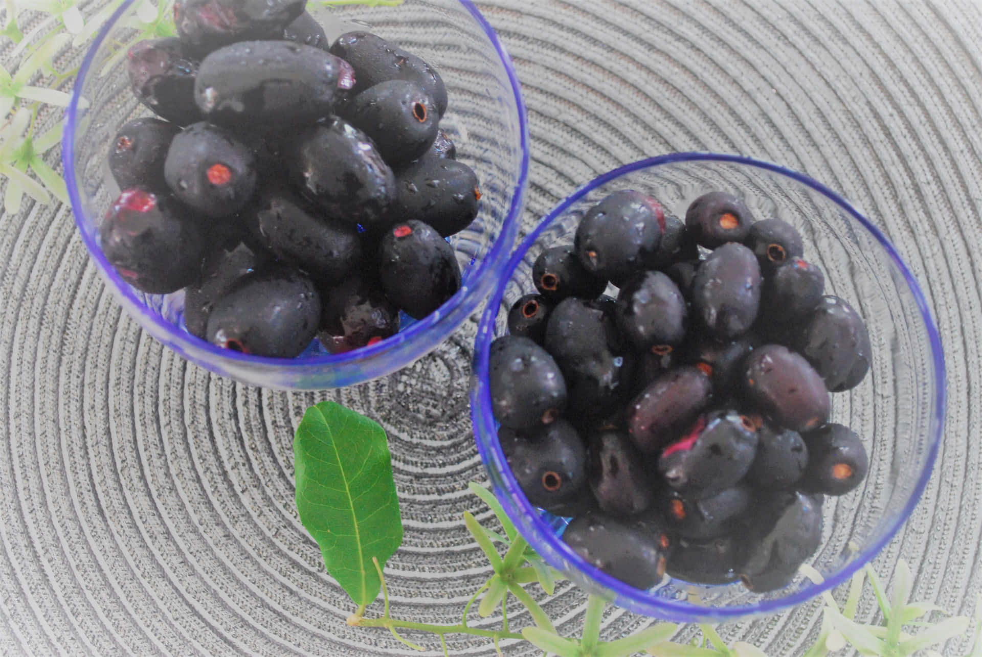 Moist Java Plums In Transparent Containers Background