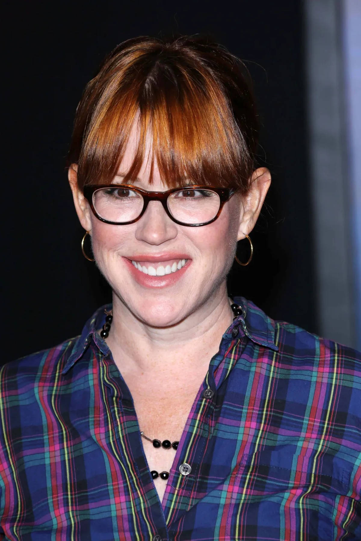 Molly Ringwald, Iconic 80s Actress, Sporting Nerdy Glasses Background