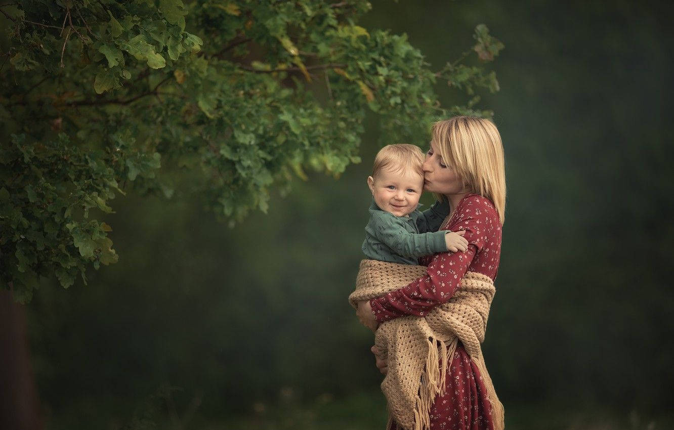 Mom And Son Beside Tree Background