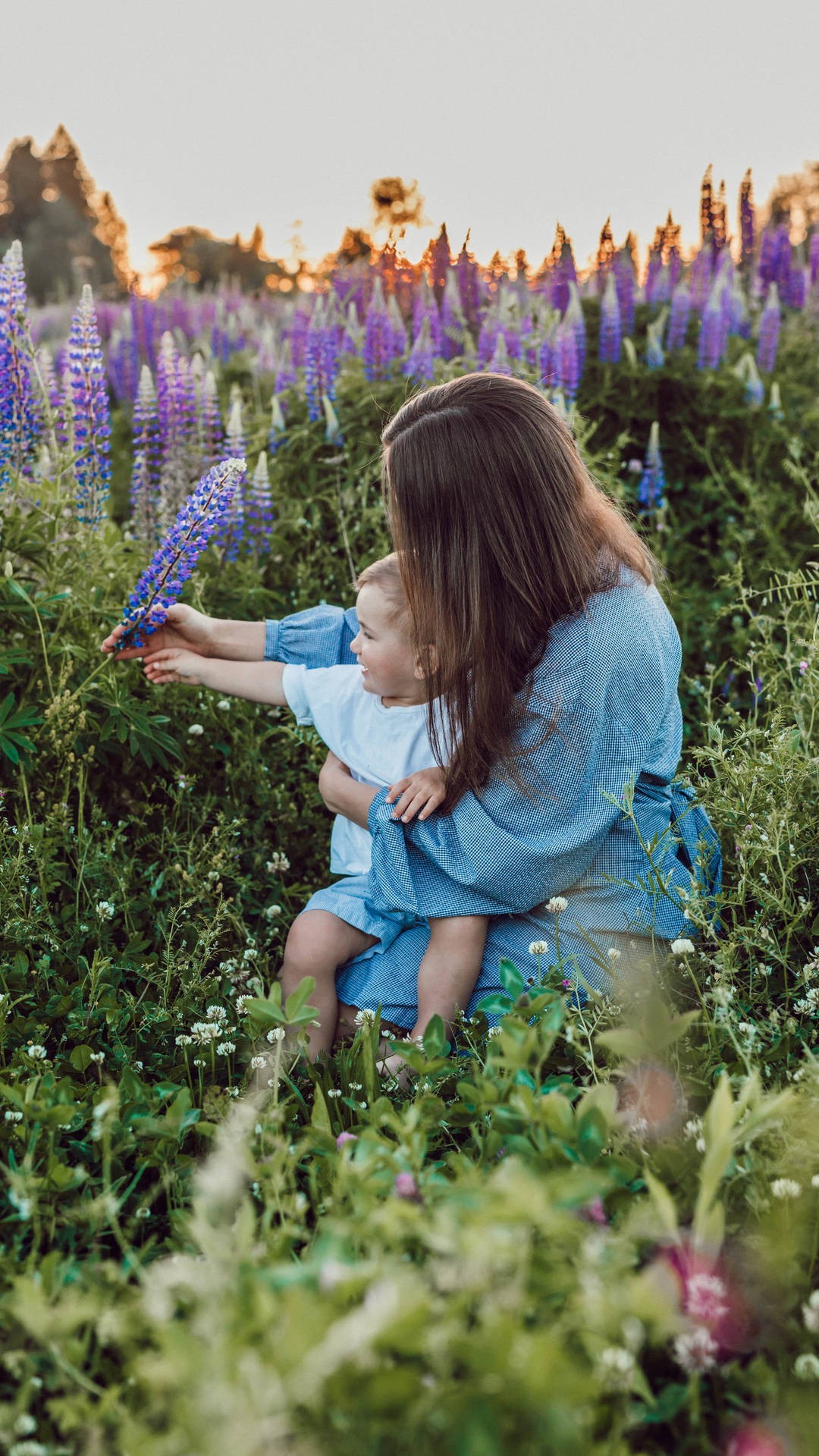 Mom And Son Field Of Flowers Background