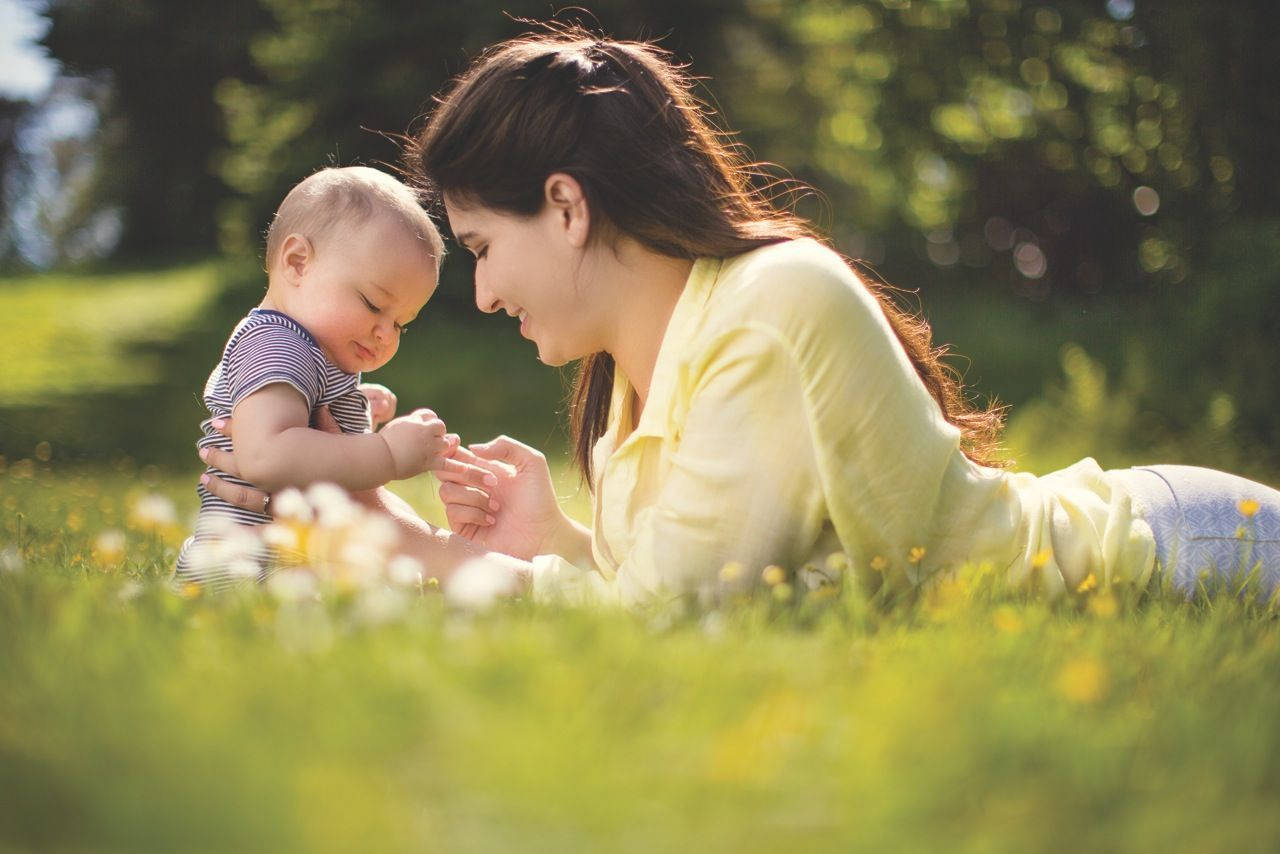 Mom And Son On Grass Background