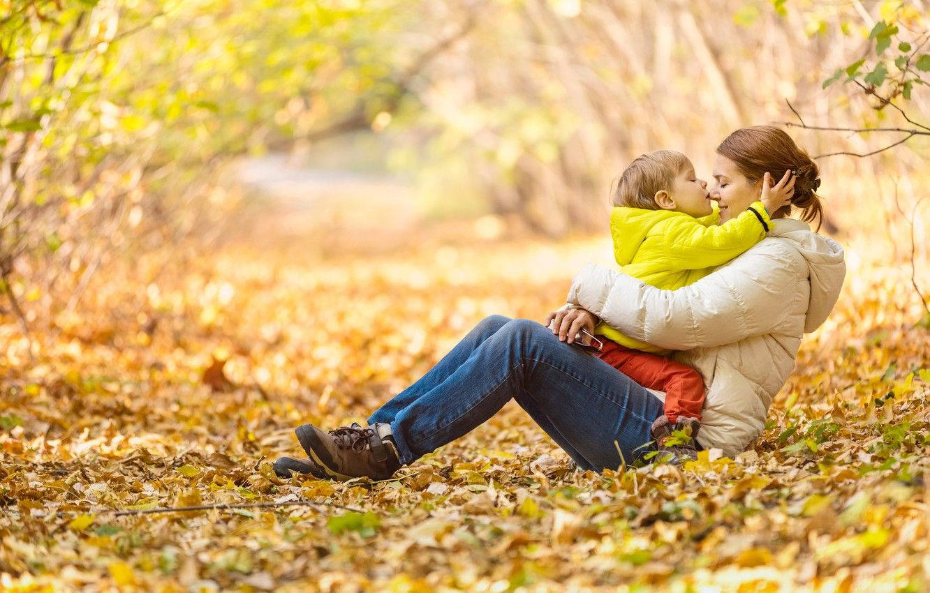 Mom And Son Playing In Autumn